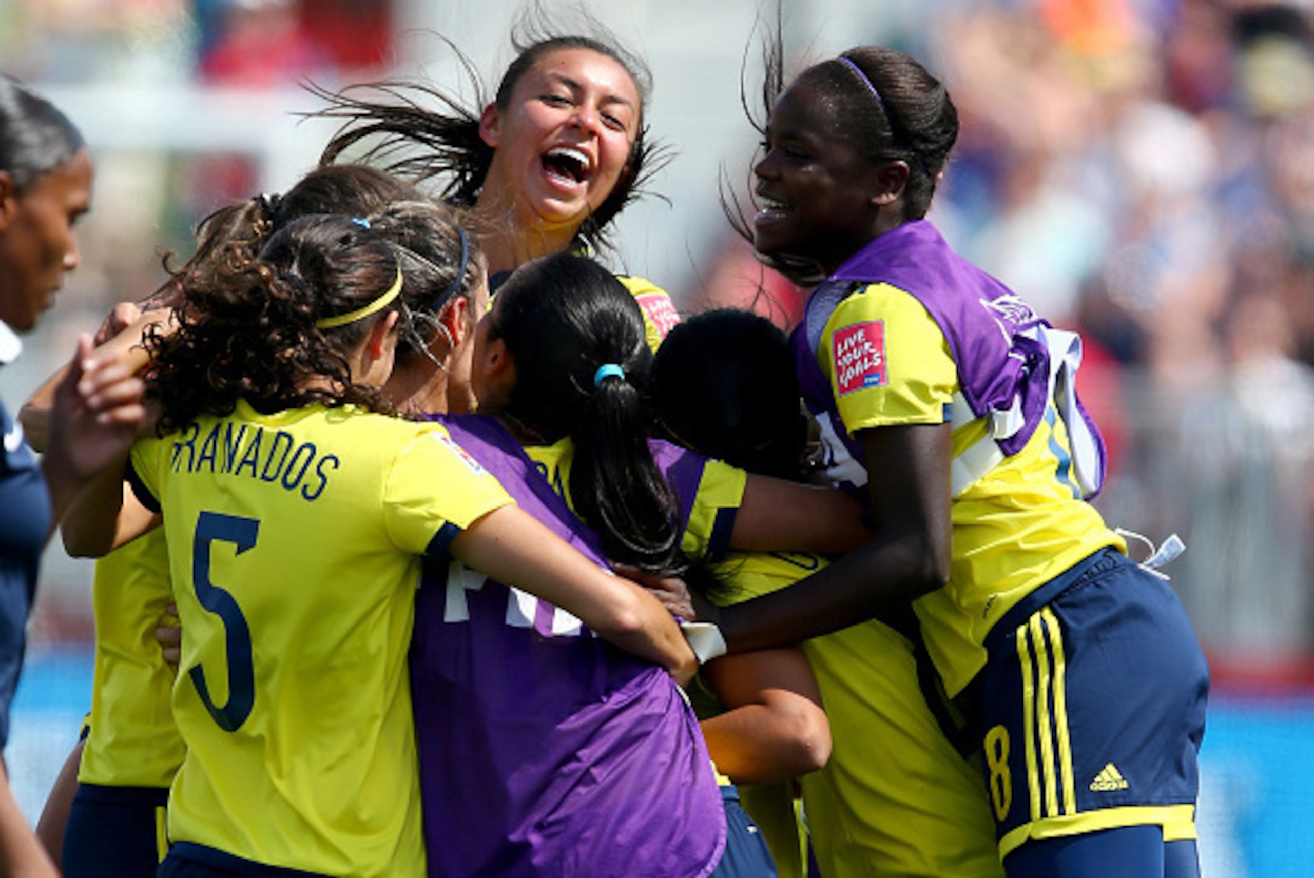 MONCTON, NB - JUNE 13:  Yisela Cuesta #18 of Colombia and the rest of the team celebrate the win over France during the FIFA Women's World Cup 2015 Group F match at Moncton Stadium on June 13, 2015 in Moncton, Canada.  (Photo by Elsa/Getty Images)