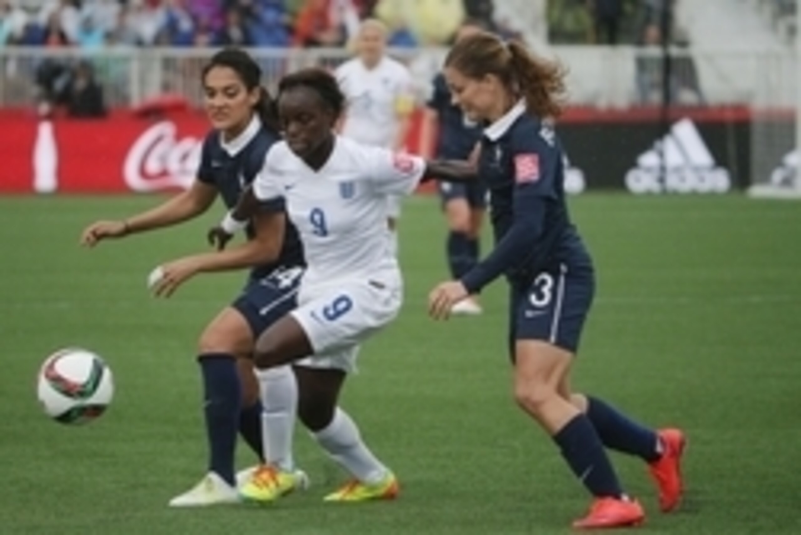 Jun 9, 2015; Moncton, New Brunswick, CAN; England forward Eniola Aluko (9) chases after the ball between France midfielder Louisa Necib (14) and defender Laure Boulleau (3) in a Group F soccer match in the 2015 FIFA women's World Cup at Moncton Stadium. M