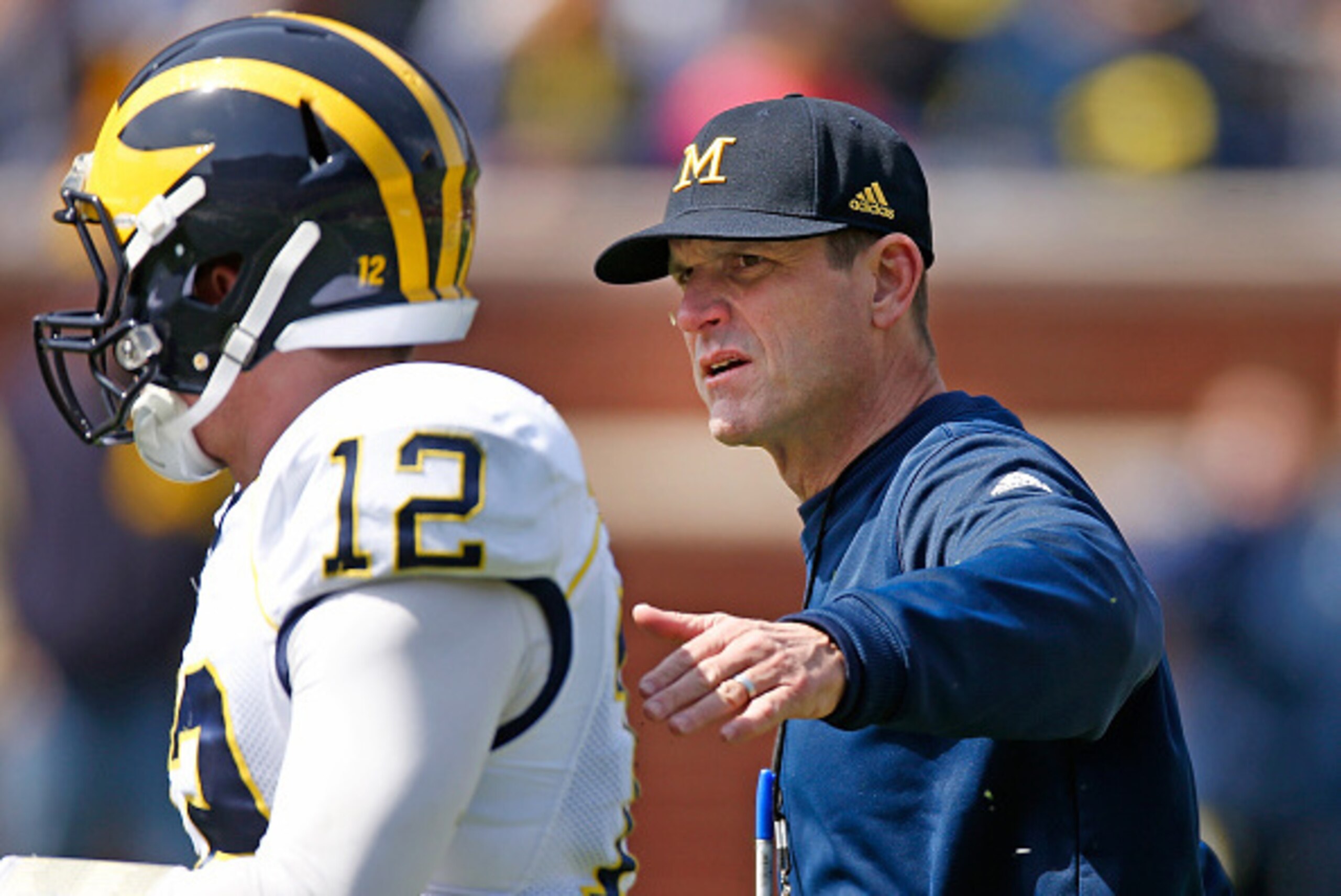 ANN ARBOR, MI - APRIL 04: Head coach Jim Harbaugh of the Michigan Wolverines talks with Alex Malzone #12 during the Michigan Football Spring Game on April 4, 2015 at Michigan Stadium in Ann Arbor, Michigan.  (Photo by Gregory Shamus/Getty Images)