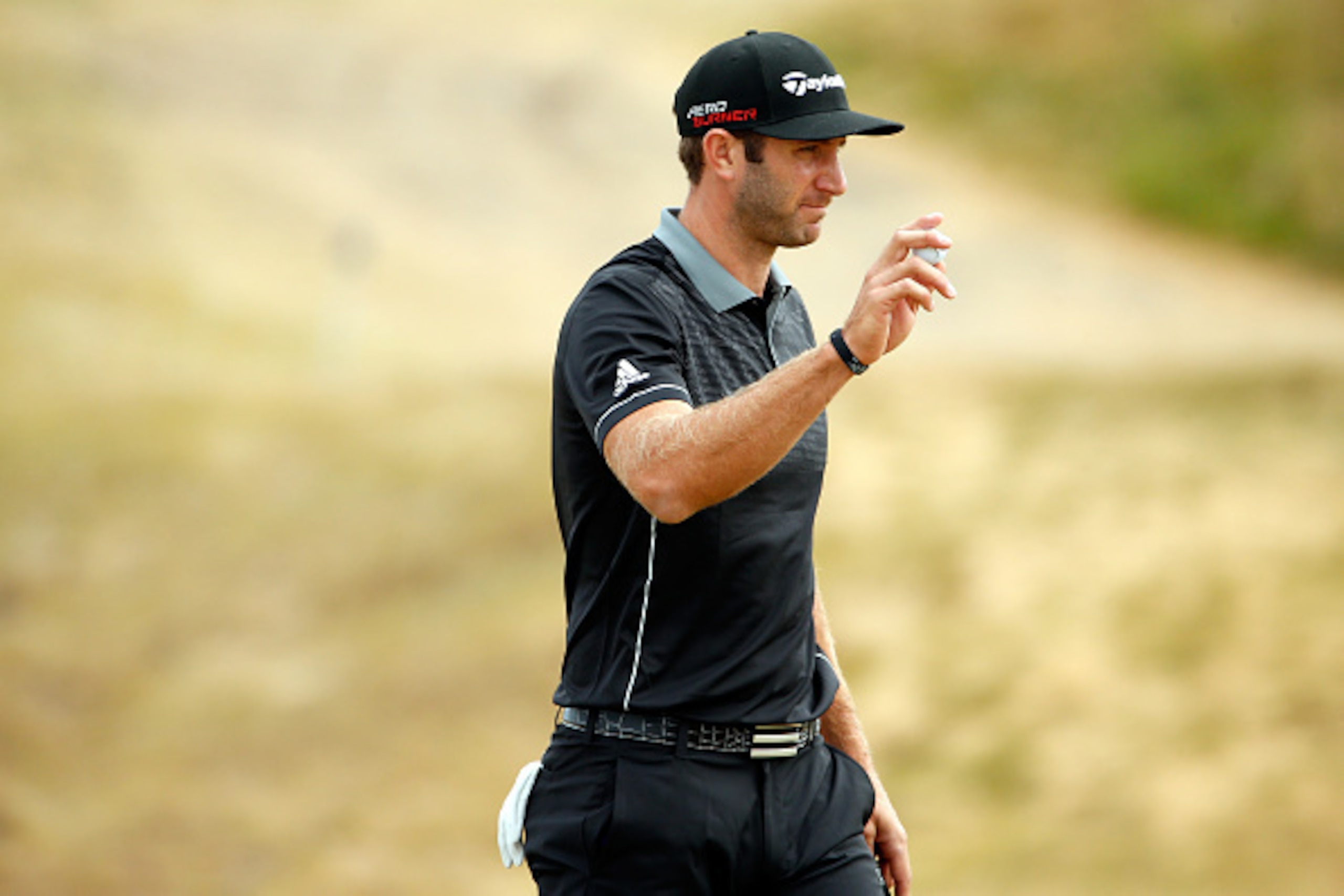 UNIVERSITY PLACE, WA - JUNE 18:  Dustin Johnson of the United States waves to the gallery on the 18th green during the first round of the 115th U.S. Open Championship at Chambers Bay on June 18, 2015 in University Place, Washington.  (Photo by Ezra Shaw/G