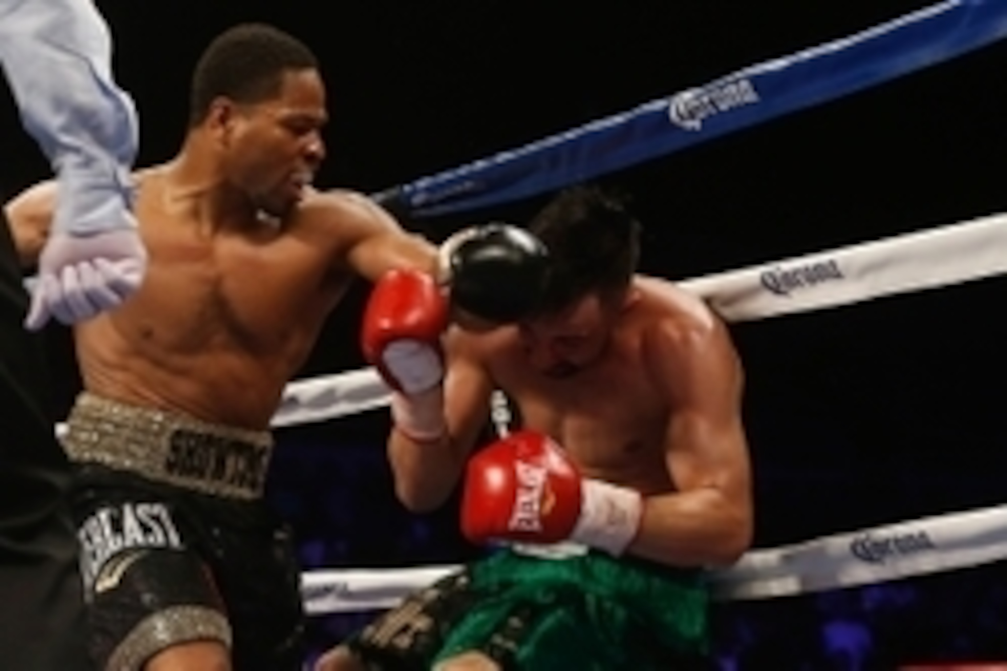 Apr 19, 2014; Washington, DC, USA; Shawn Porter (black gloves and Paulie Malignaggi (red gloves) in action during their bout at DC Armory. Mandatory Credit: Geoff Burke-USA TODAY Sports