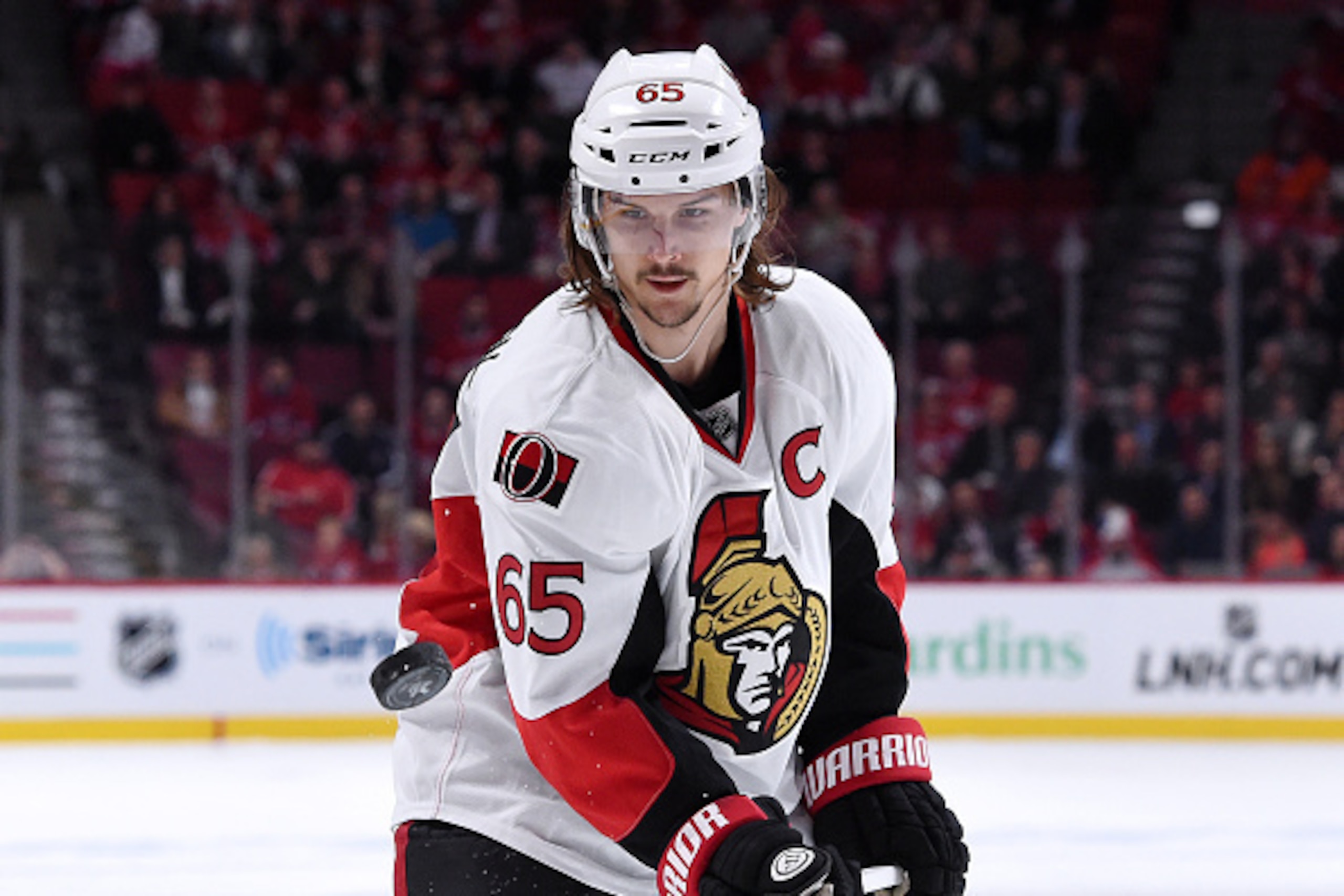 MONTREAL, QC - APRIL 24:  Erik Karlsson #65 of the Ottawa Senators picks up the puck on the fifth and final goal by Bobby Ryan #6 (not pictured) during Game Five of the Eastern Conference Quarterfinals of the 2015 NHL Stanley Cup Playoffs at the Bell Cent