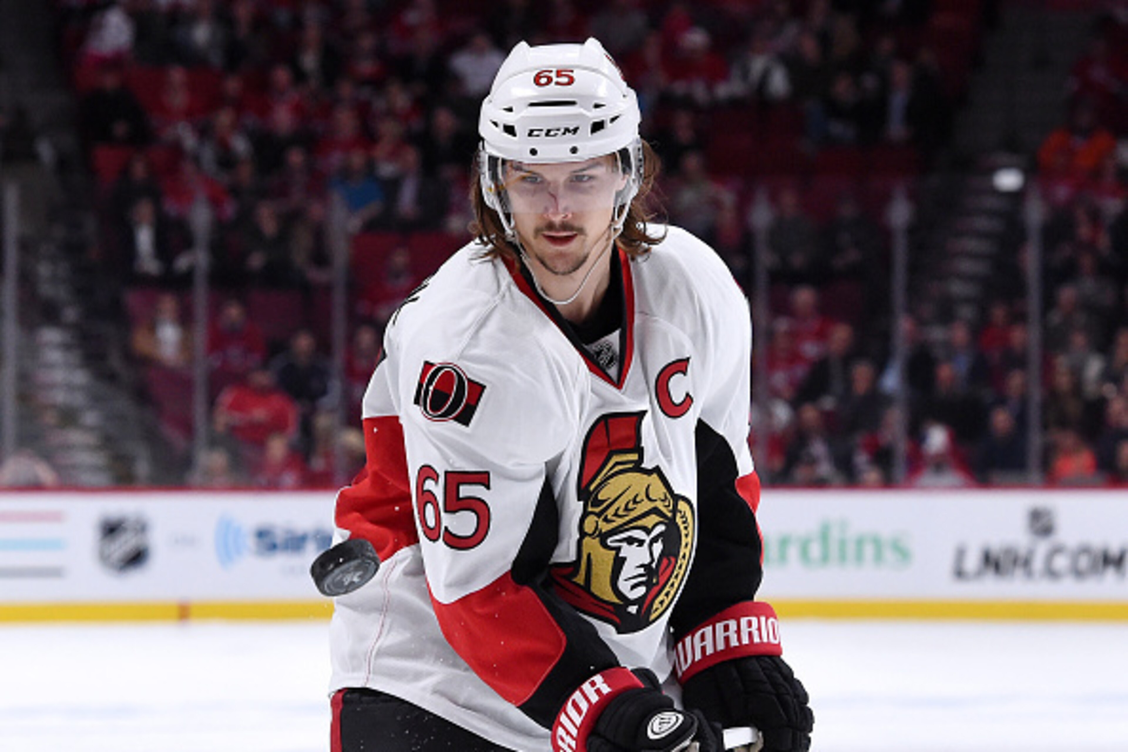 MONTREAL, QC - APRIL 24:  Erik Karlsson #65 of the Ottawa Senators picks up the puck on the fifth and final goal by Bobby Ryan #6 (not pictured) during Game Five of the Eastern Conference Quarterfinals of the 2015 NHL Stanley Cup Playoffs at the Bell Cent