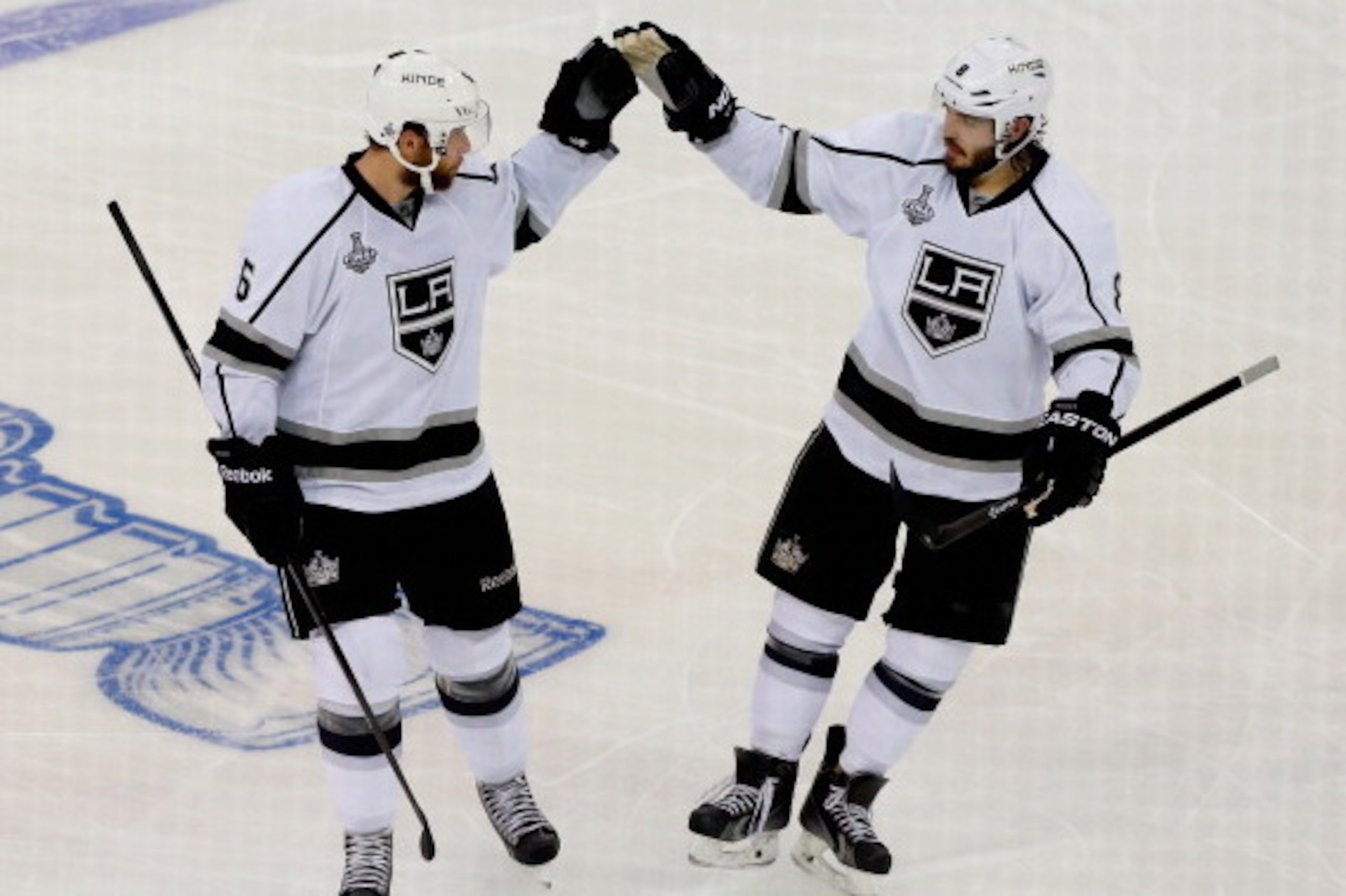 NEW YORK, NY - JUNE 09:  Jake Muzzin #6 and Drew Doughty #8 of the Los Angeles Kings celebrate Muzzin's goal on Henrik Lundqvist #30 of the New York Rangers during the first period of Game Three of the 2014 NHL Stanley Cup Final at Madison Square Garden o