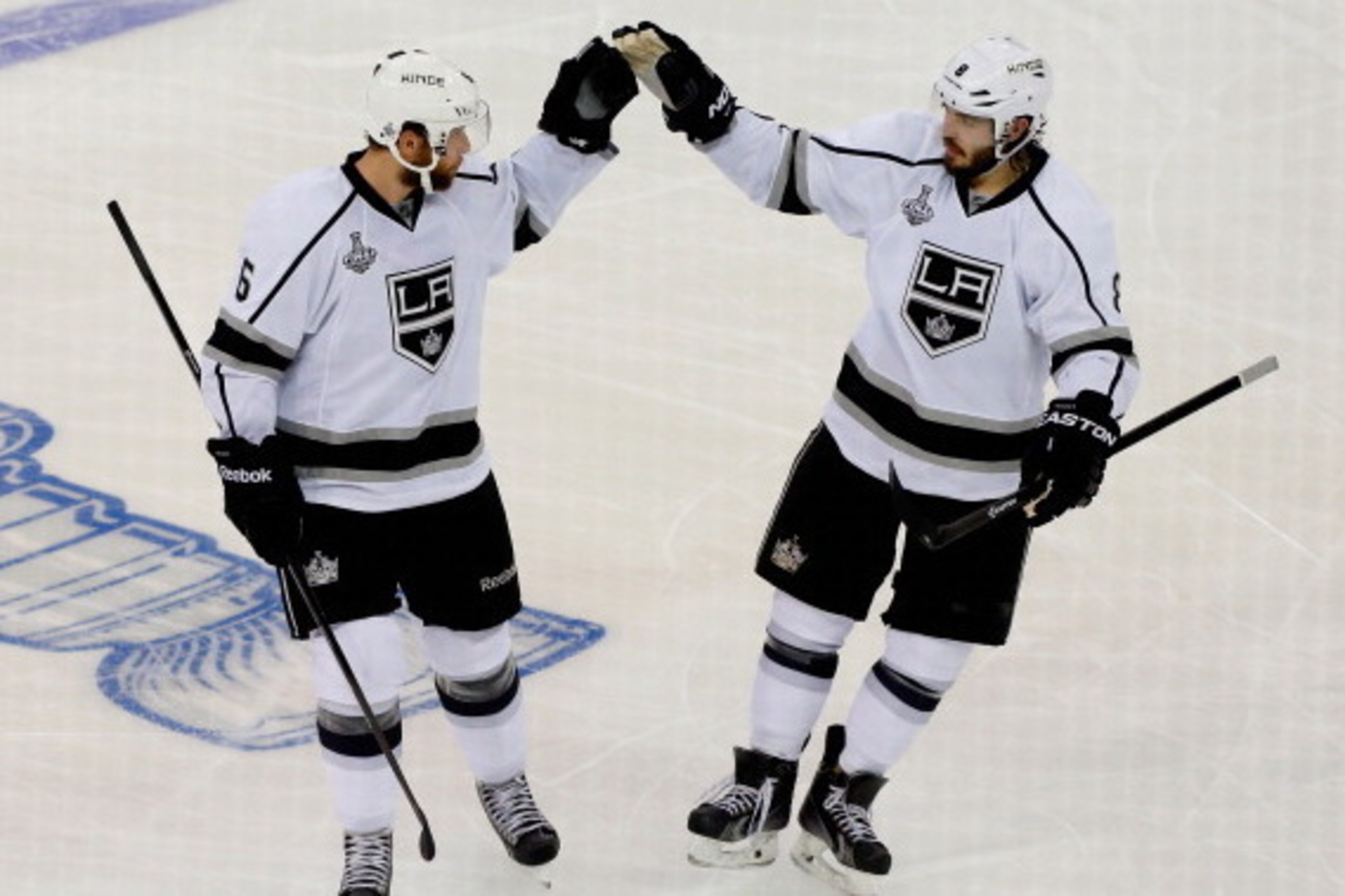 NEW YORK, NY - JUNE 09:  Jake Muzzin #6 and Drew Doughty #8 of the Los Angeles Kings celebrate Muzzin's goal on Henrik Lundqvist #30 of the New York Rangers during the first period of Game Three of the 2014 NHL Stanley Cup Final at Madison Square Garden o