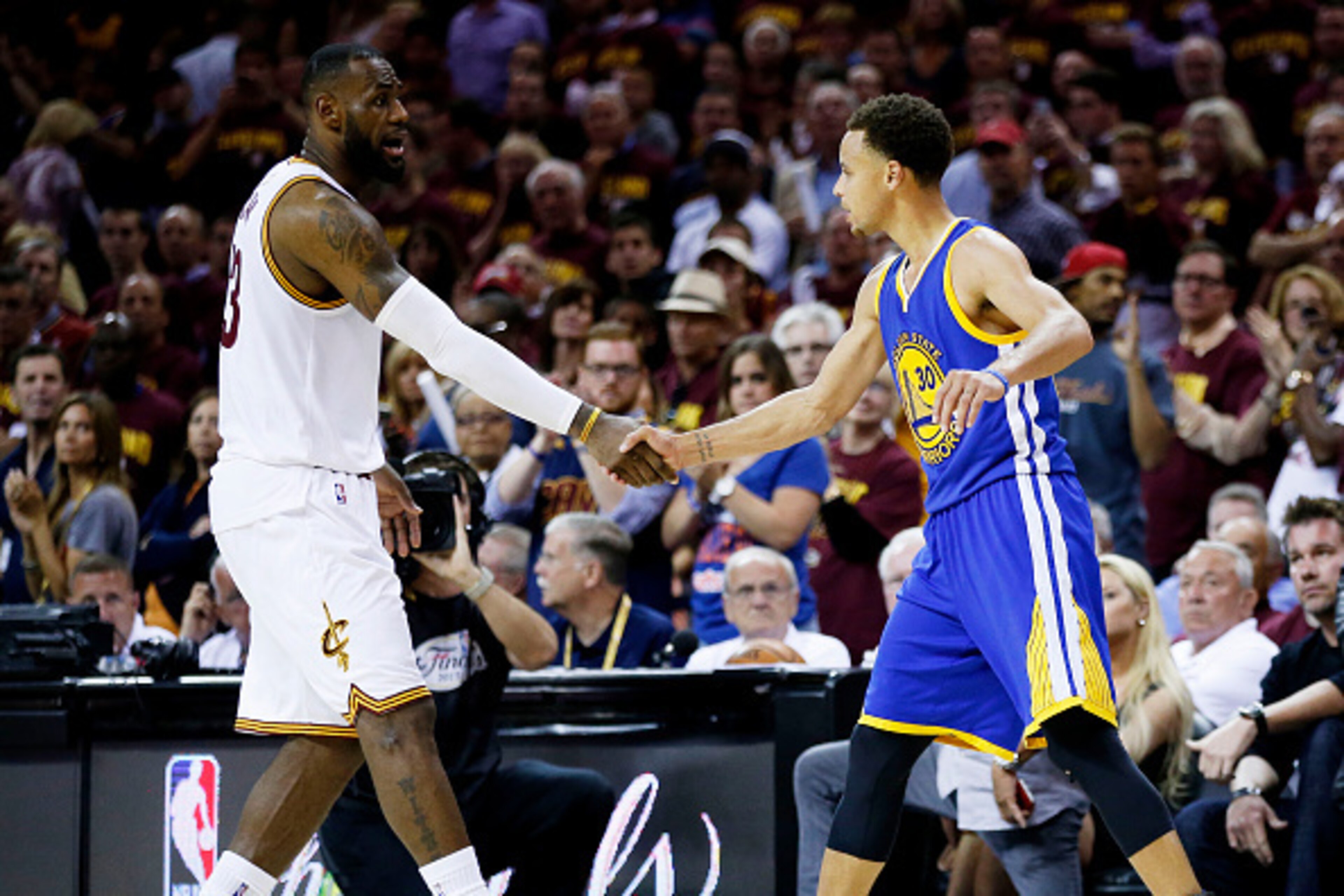 CLEVELAND, OH - JUNE 16:  LeBron James #23 of the Cleveland Cavaliers shakes hands with Stephen Curry #30 of the Golden State Warriors after the Warriors defeated the Cavs 105 to 97 to win Game Six of the 2015 NBA Finals at Quicken Loans Arena on June 16,