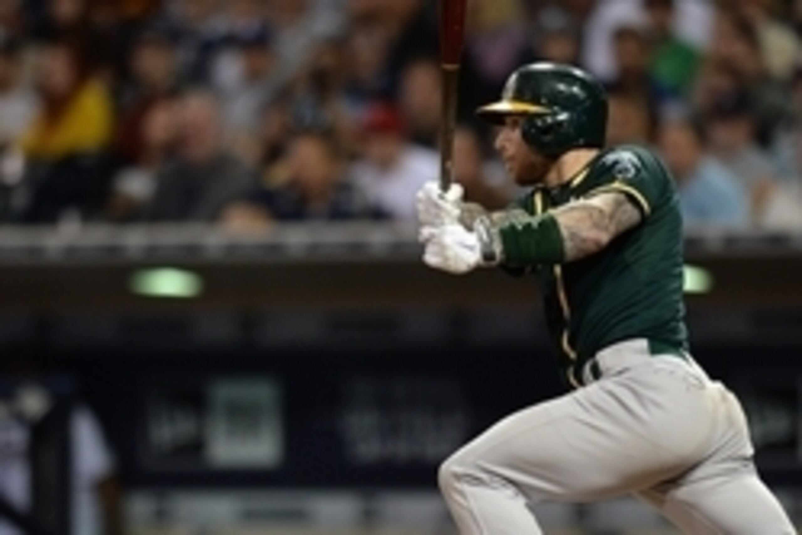 Jun 15, 2015; San Diego, CA, USA; Oakland Athletics third baseman Brett Lawrie (15) hits an RBI single during the fifth inning against the San Diego Padres at Petco Park. Mandatory Credit: Jake Roth-USA TODAY Sports