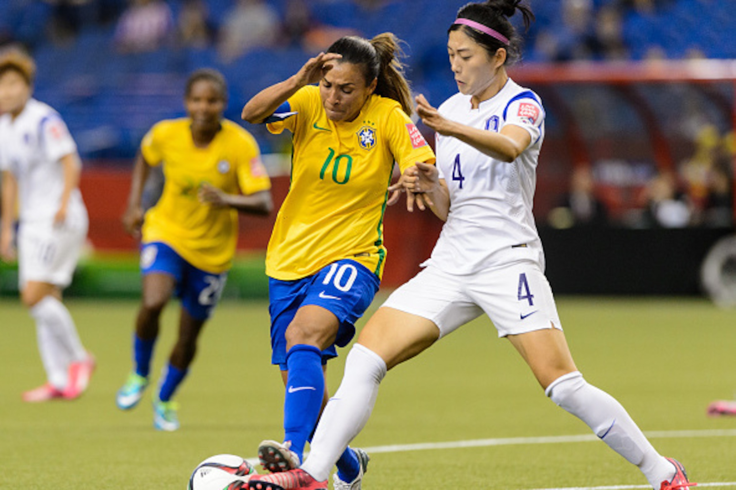 MONTREAL, QC - JUNE 09:  Marta #10 of Brazil tries to move the ball past Shim Seojeon #4 of Korea Republic during the 2015 FIFA Women's World Cup Group E match at Olympic Stadium on June 9, 2015 in Montreal, Quebec, Canada. Brazil defeated Korea Republic 