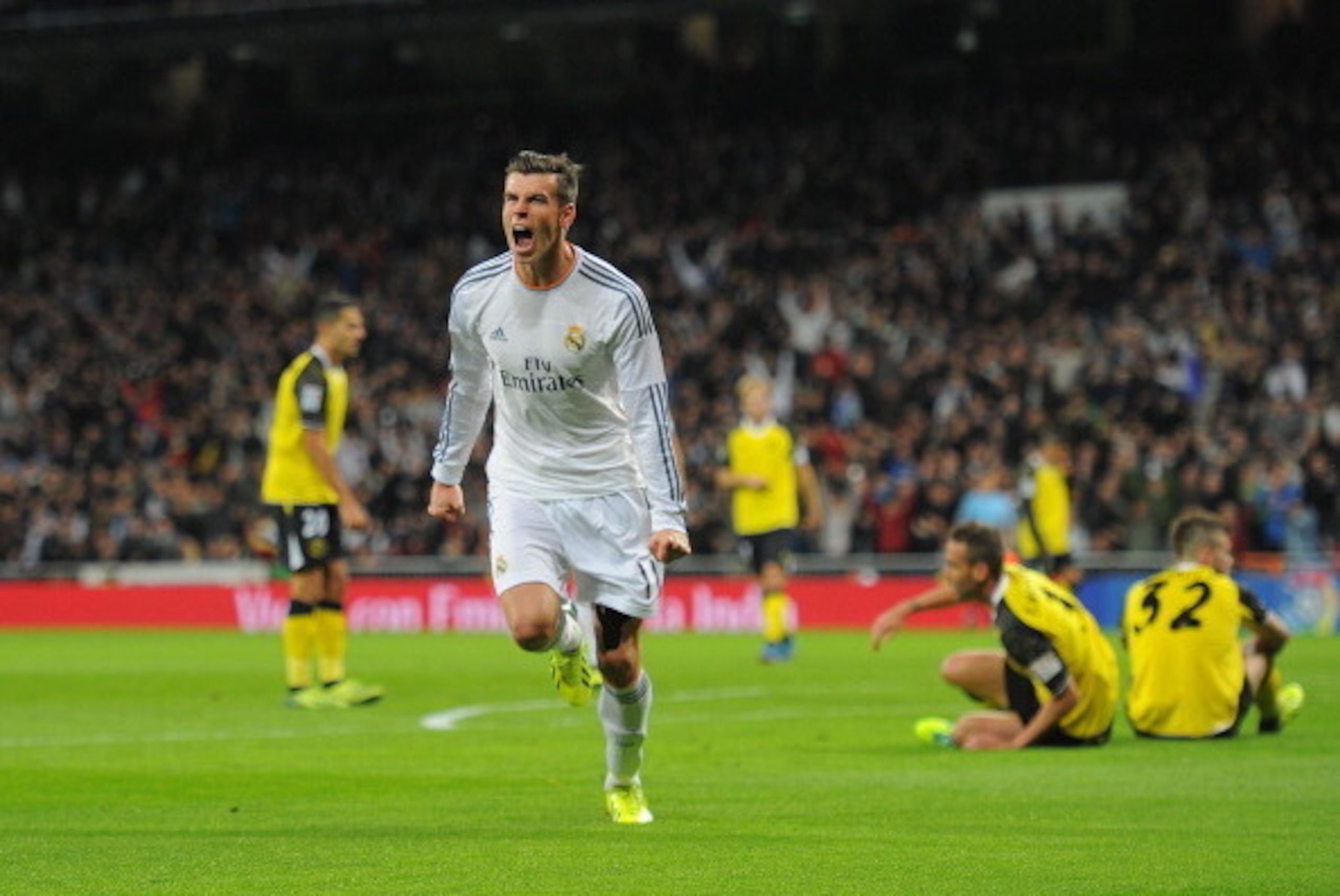 MADRID, SPAIN - OCTOBER 30:  Gareth Bale of Real Madrid CF celebrates after scoring Real's opening goal during the La Liga match between Real Madrid CF and Sevilla FC at the Santiago Bernabeu Stadium on October 30, 2013 in Madrid, Spain.  (Photo by Denis 