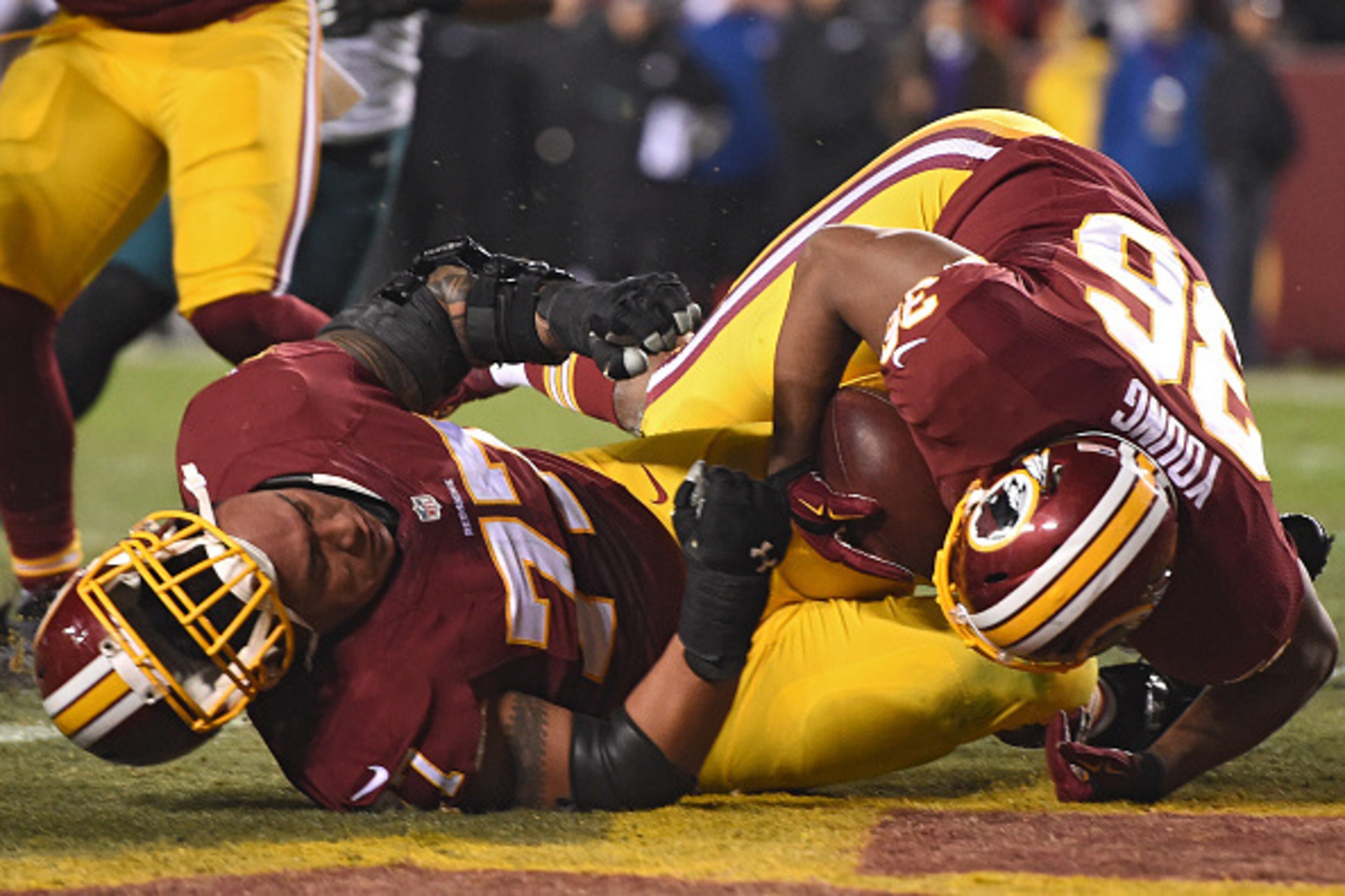 LANDOVER, MD - DECEMBER 20: Darrel Young #36 of the Washington Redskins falls over Shawn Lauvao #77 to score a touchdown in the third quarter against the Philadelphia Eagles at FedExField on December 20, 2014 in Landover, Maryland. The Washington Redskins