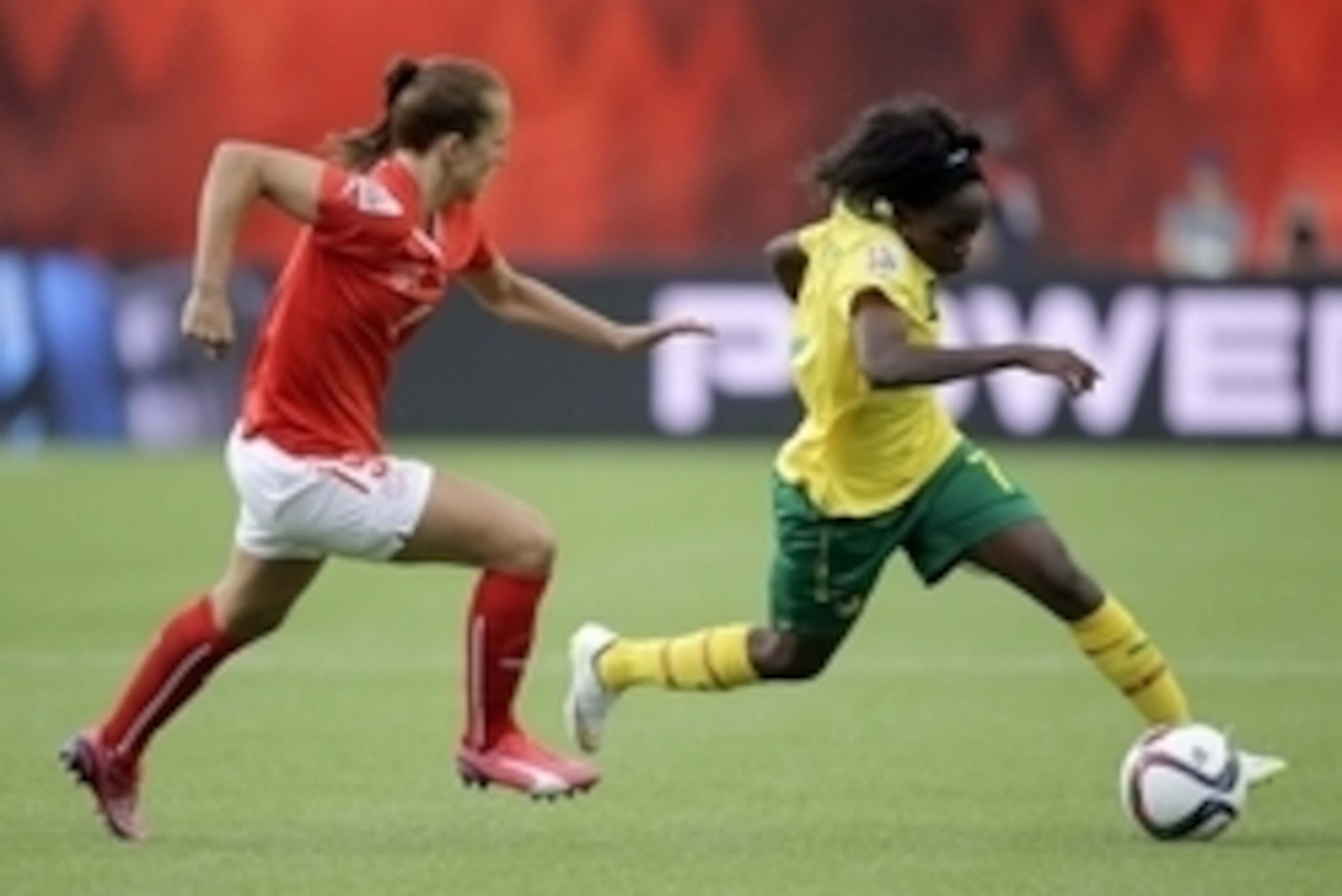 Jun 16, 2015; Edmonton, Alberta, CAN; Cameroon forward Gabrielle Onguene (7) controls the ball as Switzerland midfielder Lia Waelti (9) defends during the second half in a Group C soccer match in the 2015 FIFA women's World Cup at Commonwealth Stadium. Ma