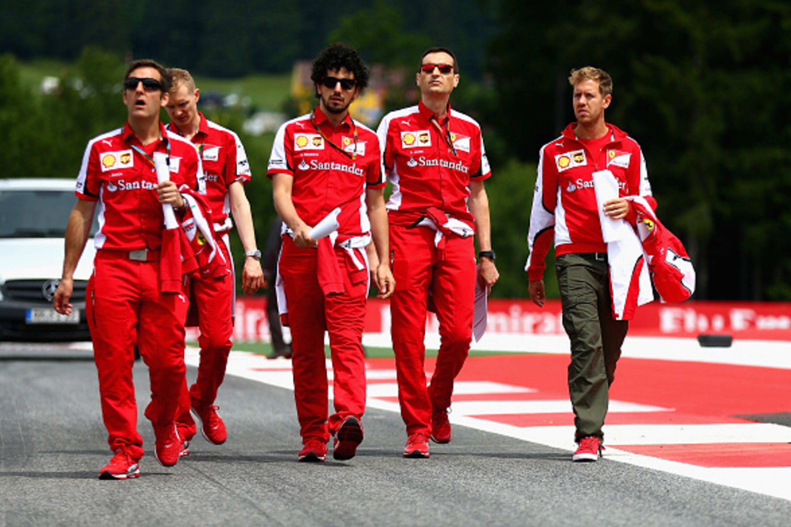 SPIELBERG, AUSTRIA - JUNE 18:  Sebastian Vettel of Germany and Ferrari walks the track with members of his team during previews to the Formula One Grand Prix of Austria at Red Bull Ring on June 18, 2015 in Spielberg, Austria.  (Photo by Clive Mason/Getty 