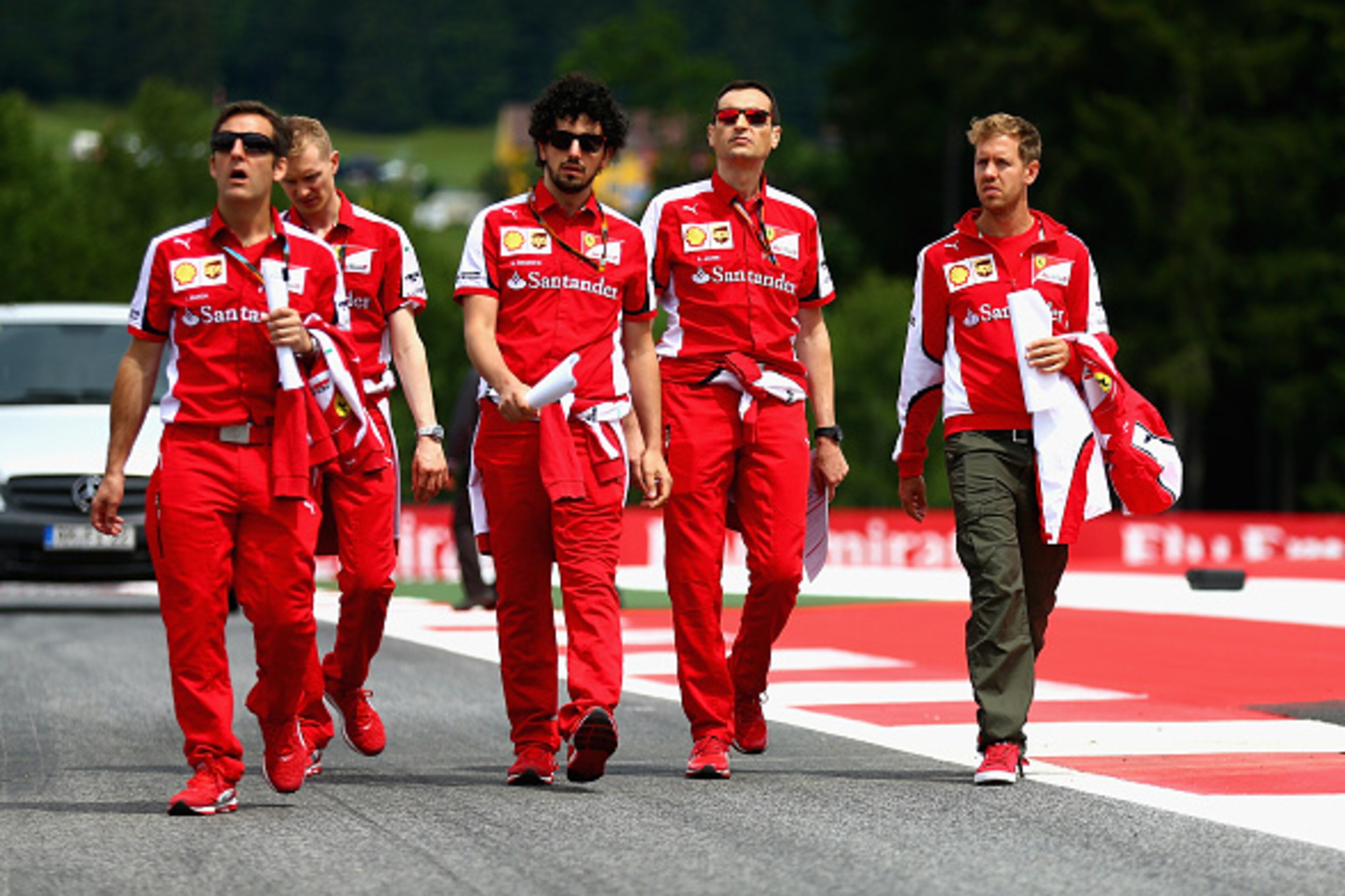 SPIELBERG, AUSTRIA - JUNE 18:  Sebastian Vettel of Germany and Ferrari walks the track with members of his team during previews to the Formula One Grand Prix of Austria at Red Bull Ring on June 18, 2015 in Spielberg, Austria.  (Photo by Clive Mason/Getty 