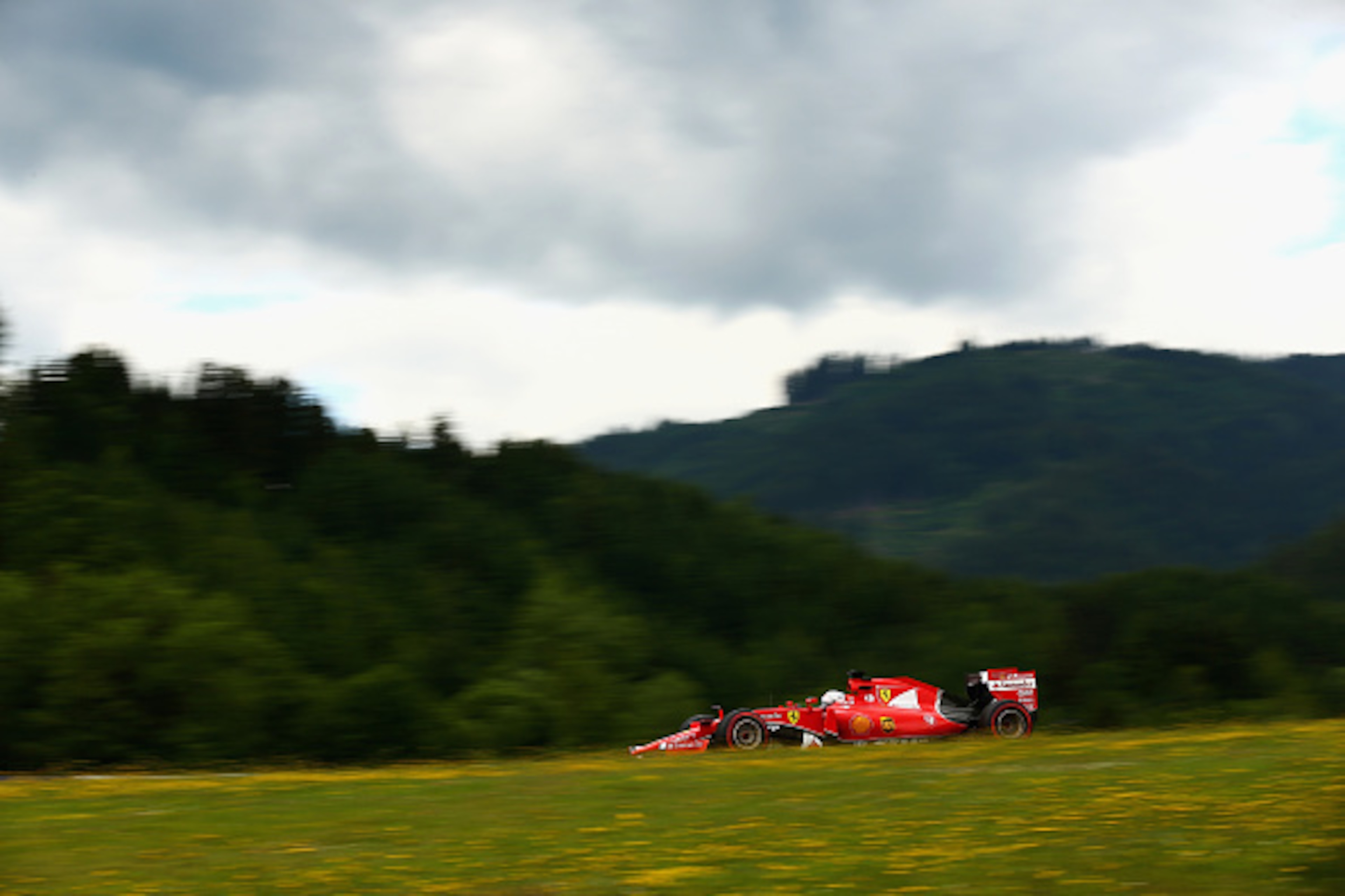 SPIELBERG, AUSTRIA - JUNE 19:  Sebastian Vettel of Germany and Ferrari drives during practice for the Formula One Grand Prix of Austria at Red Bull Ring on June 19, 2015 in Spielberg, Austria.  (Photo by Clive Mason/Getty Images)