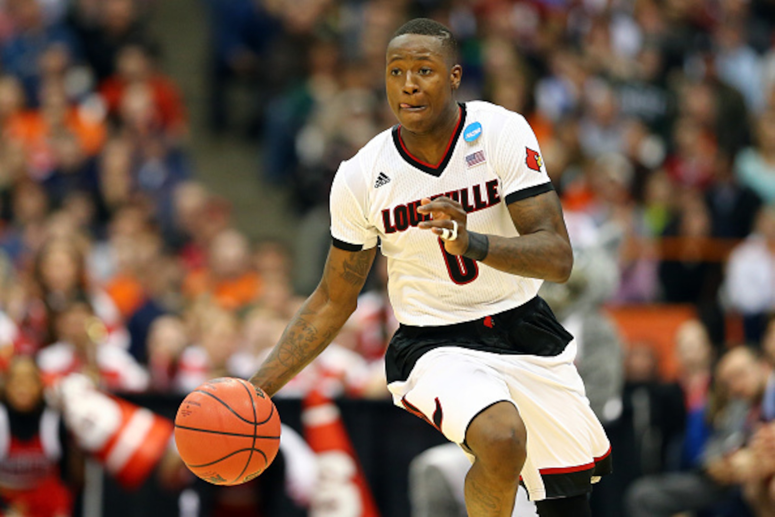 SYRACUSE, NY - MARCH 27:  Terry Rozier #0 of the Louisville Cardinals dribbles against the North Carolina State Wolfpack in the second half of the game during the East Regional Semifinal of the 2015 NCAA Men's Basketball Tournament at the Carrier Dome on 