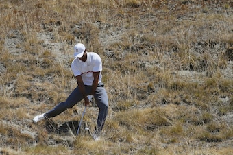 Tiger Woods demonstrating difficulty of lie angles and slopes at Chambers Bay.