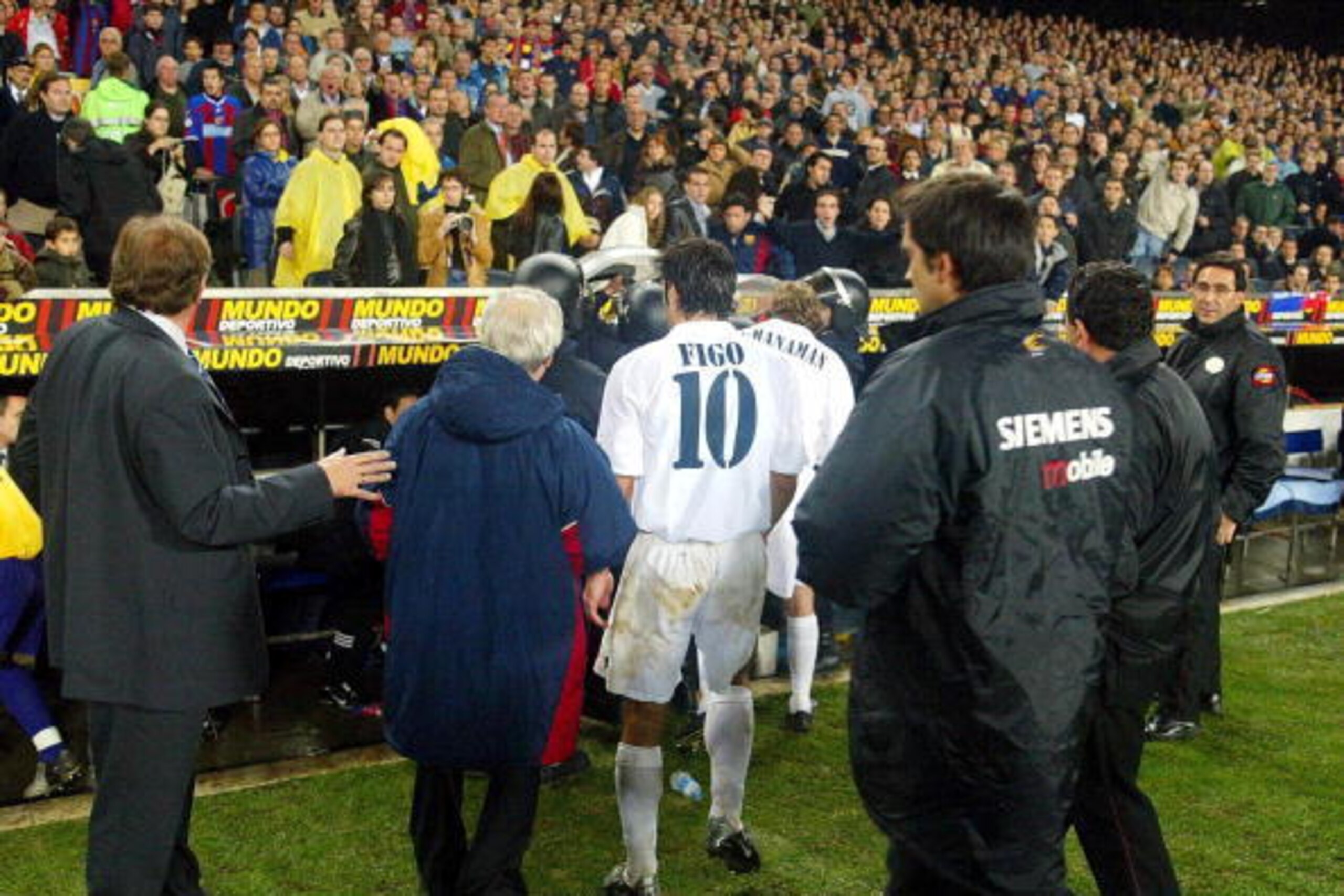 BARCELONA - NOVEMBER 23:  Luis Figo of Real Madrid leaves the pitch as play was suspended during the La Liga match between FC Barcelona and Real Madrid played at the Nou Camp Stadium, Barcelona, Spain on November 23, 2002. (Photo by Firo Foto/Getty Images