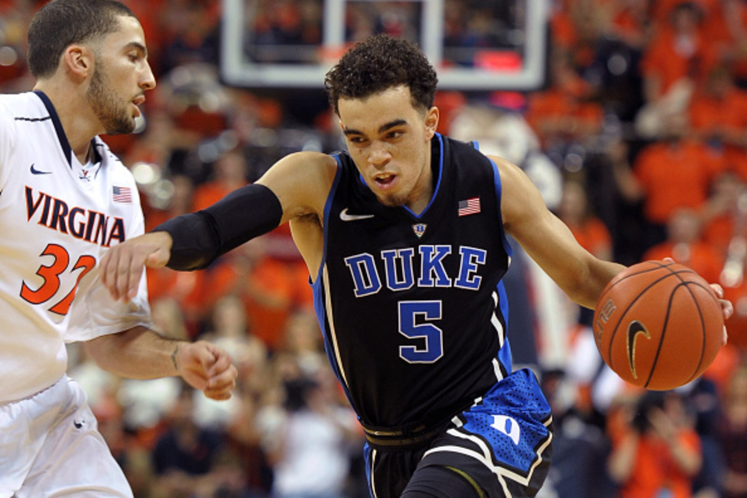 CHARLOTTESVILLE, VA - JANUARY 31: Tyus Jones #5 of the Duke Blue Devils drives against London Perrantes #32 of the Virginia Cavaliers at John Paul Jones Arena on January 31, 2015 in Charlottesville, Virginia. (Photo by Lance King/Getty Images)