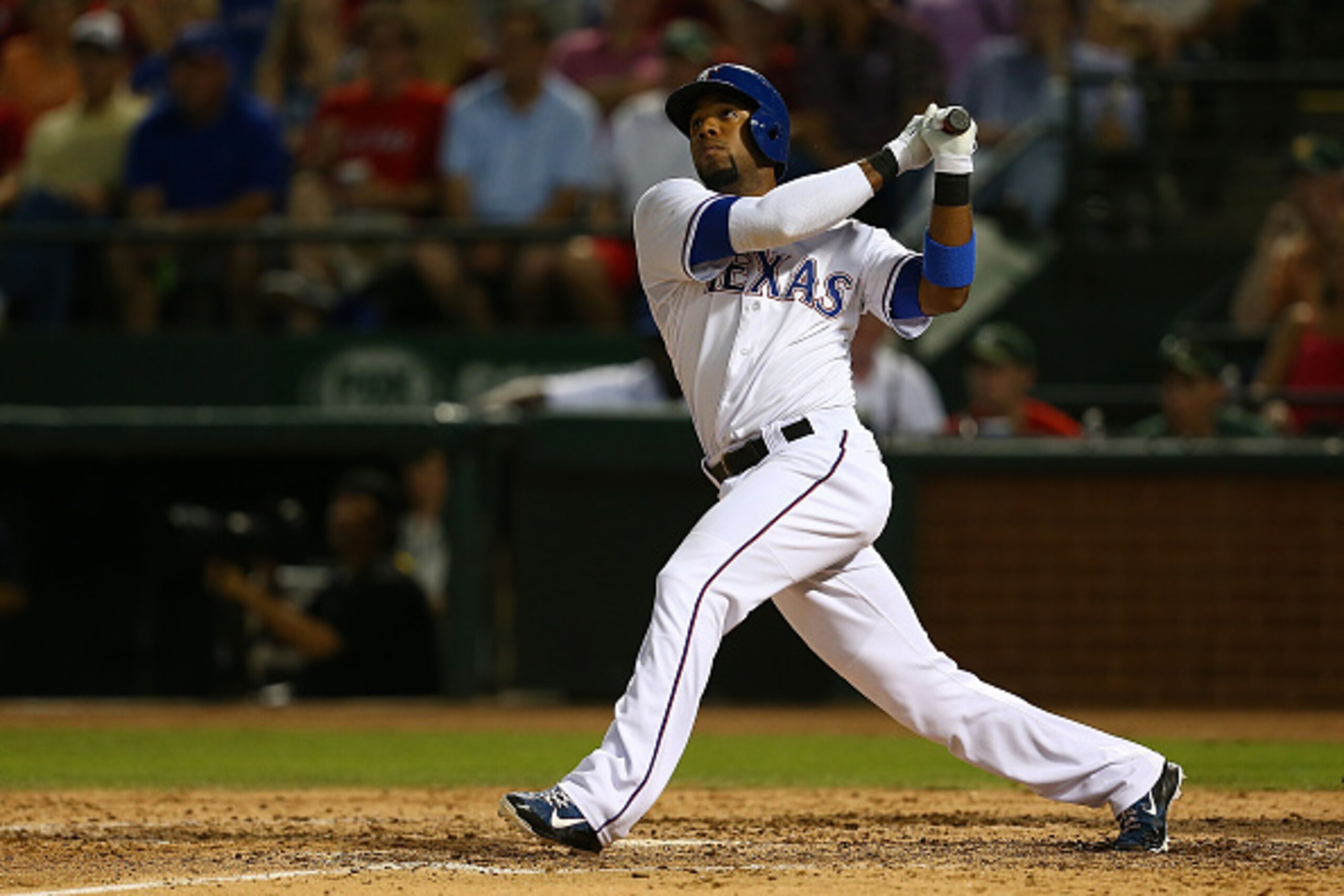ARLINGTON, TX - JUNE 12:  Elvis Andrus #1 of the Texas Rangers hits a two-run homer in the seventh inning during a game against the Minnesota Twins at Globe Life Park in Arlington on June 12, 2015 in Arlington, Texas. The Texas Rangers defeated the Minnes