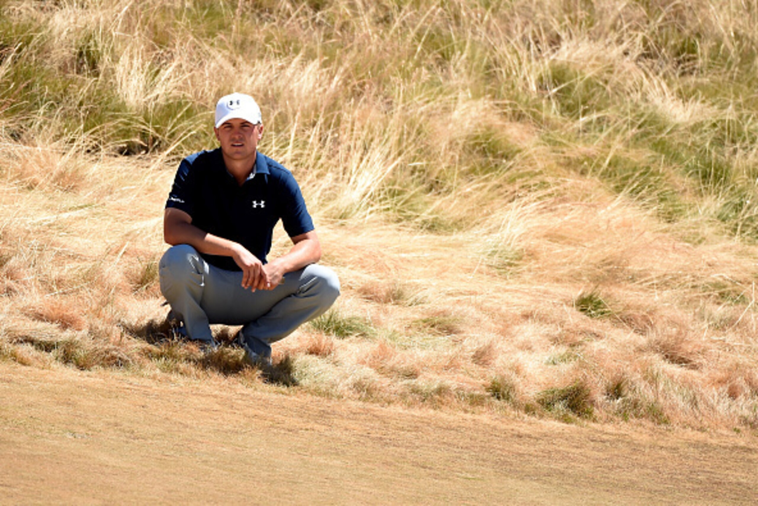 UNIVERSITY PLACE, WA - JUNE 19:  Jordan Spieth of the United States waits behind a green during the second round of the 115th U.S. Open Championship at Chambers Bay on June 19, 2015 in University Place, Washington.  (Photo by Harry How/Getty Images)