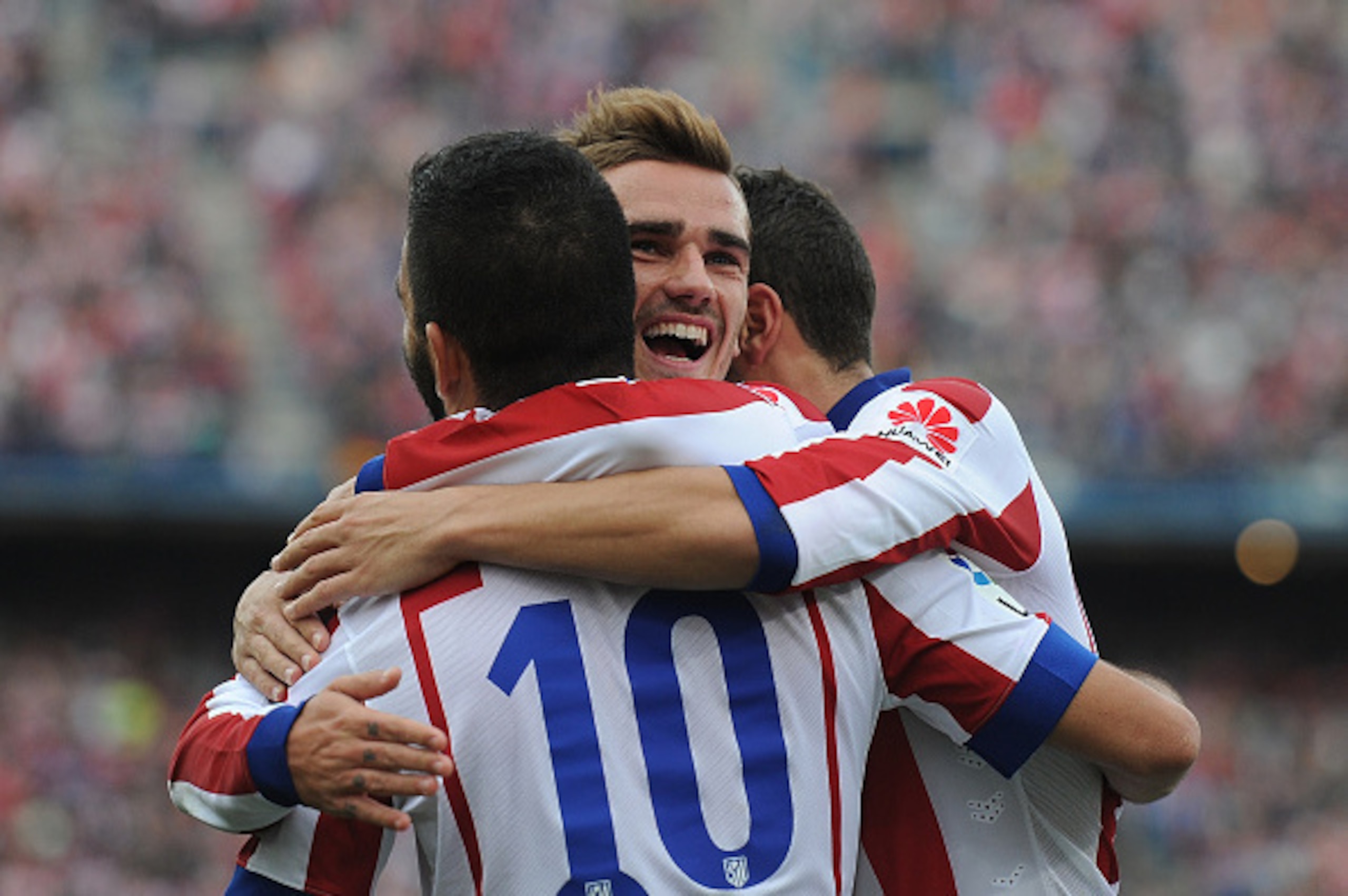 MADRID, SPAIN - NOVEMBER 22:  Antoine Griezmann of Club Atletico de Madrid celebrates with Arda Turan after scoring his team's 2nd goal during the La Liga match between Club Atletico de Madrid and Malaga CF at Vicente Calderon Stadium on November 22, 2014