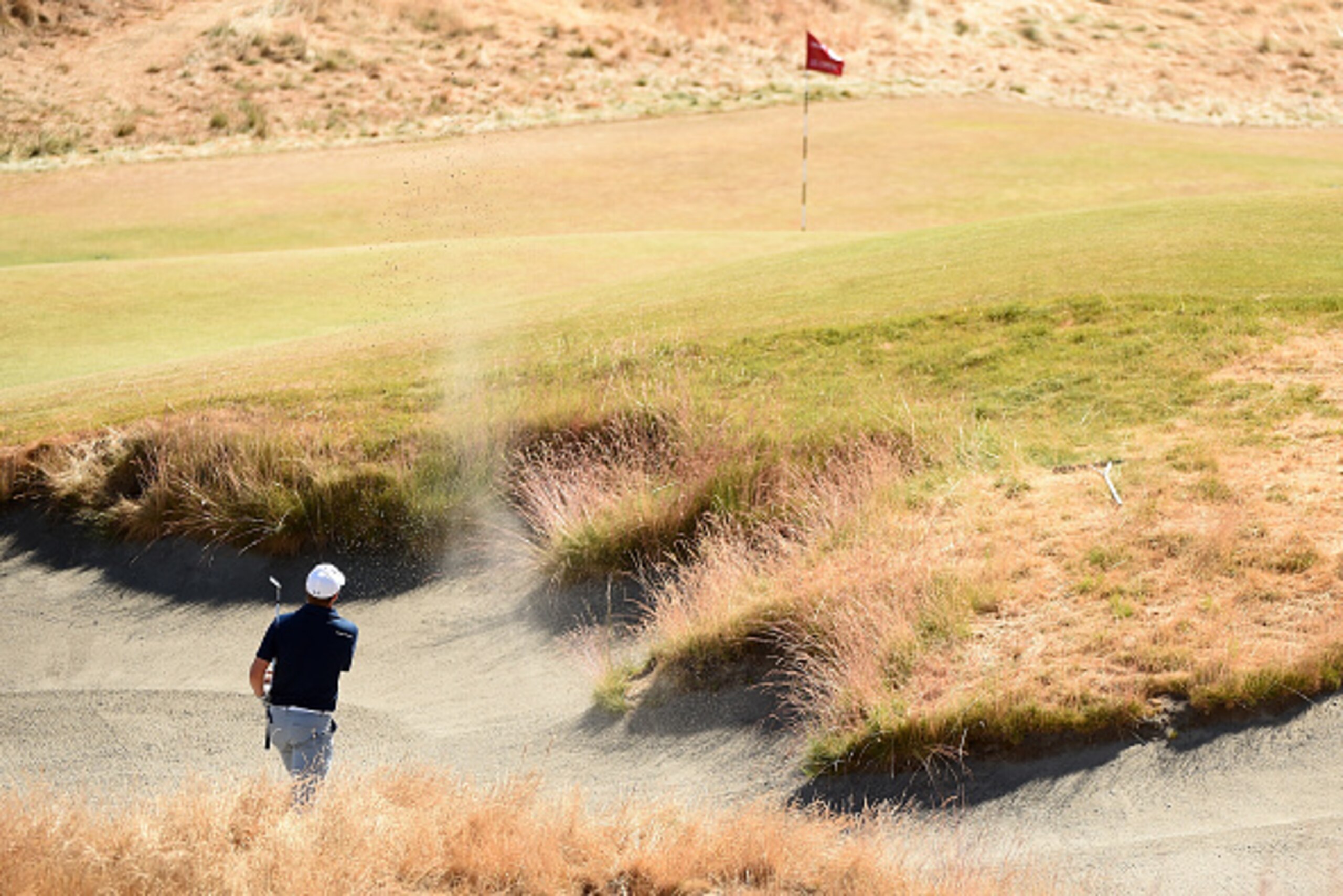 UNIVERSITY PLACE, WA - JUNE 19:  Jordan Spieth of the United States hits a shot from a greenside bunker on the 18th hole during the second round of the 115th U.S. Open Championship at Chambers Bay on June 19, 2015 in University Place, Washington.  (Photo 