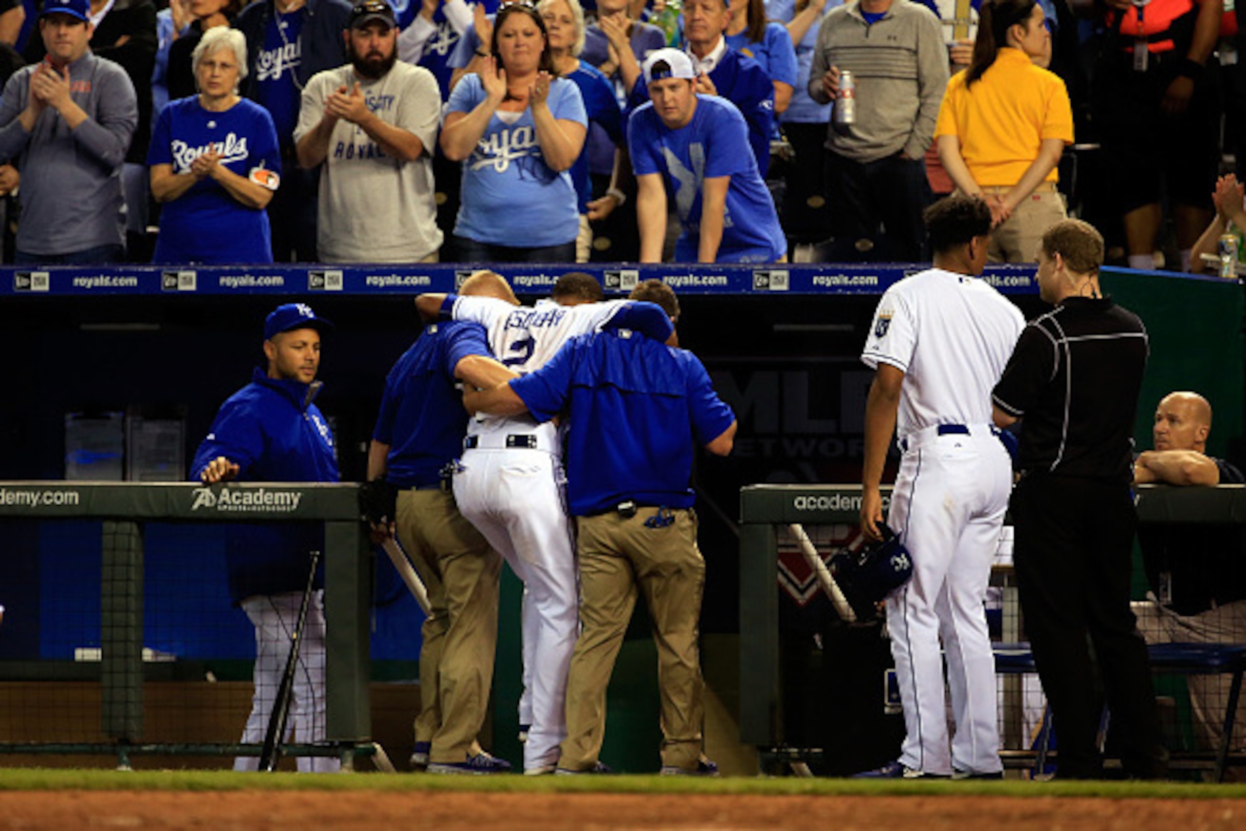 KANSAS CITY, MO - APRIL 17: Alcides Escobar #2 of the Kansas City Royals is helped off the field after being injured as Brett Lawrie #15 of the Oakland Athletics slid into him at second base during the 7th inning of the game at Kauffman Stadium on April KANSAS CITY, MO - APRIL 17: Alcides Escobar #2 of the Kansas City Royals is helped off the field after being injured as Brett Lawrie #15 of the Oakland Athletics slid into him at second base during the 7th inning of the game at Kauffman Stadium on April