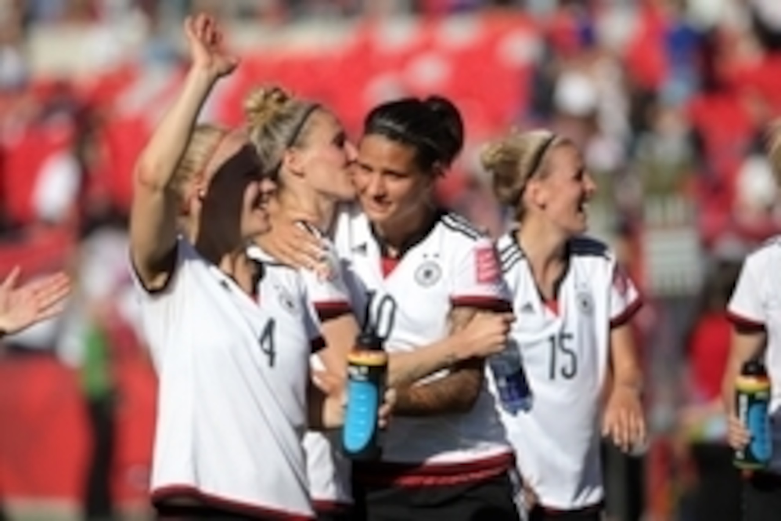 Jun 20, 2015; Ottawa, Ontario, CAN; Germany defender Jennifer Cramer (center) gives a kiss to midfielder Dzsenifer Marozsan (10) after defeating Sweden in the round of sixteen in the FIFA 2015 women's World Cup soccer tournament at Lansdowne Stadium. Germ