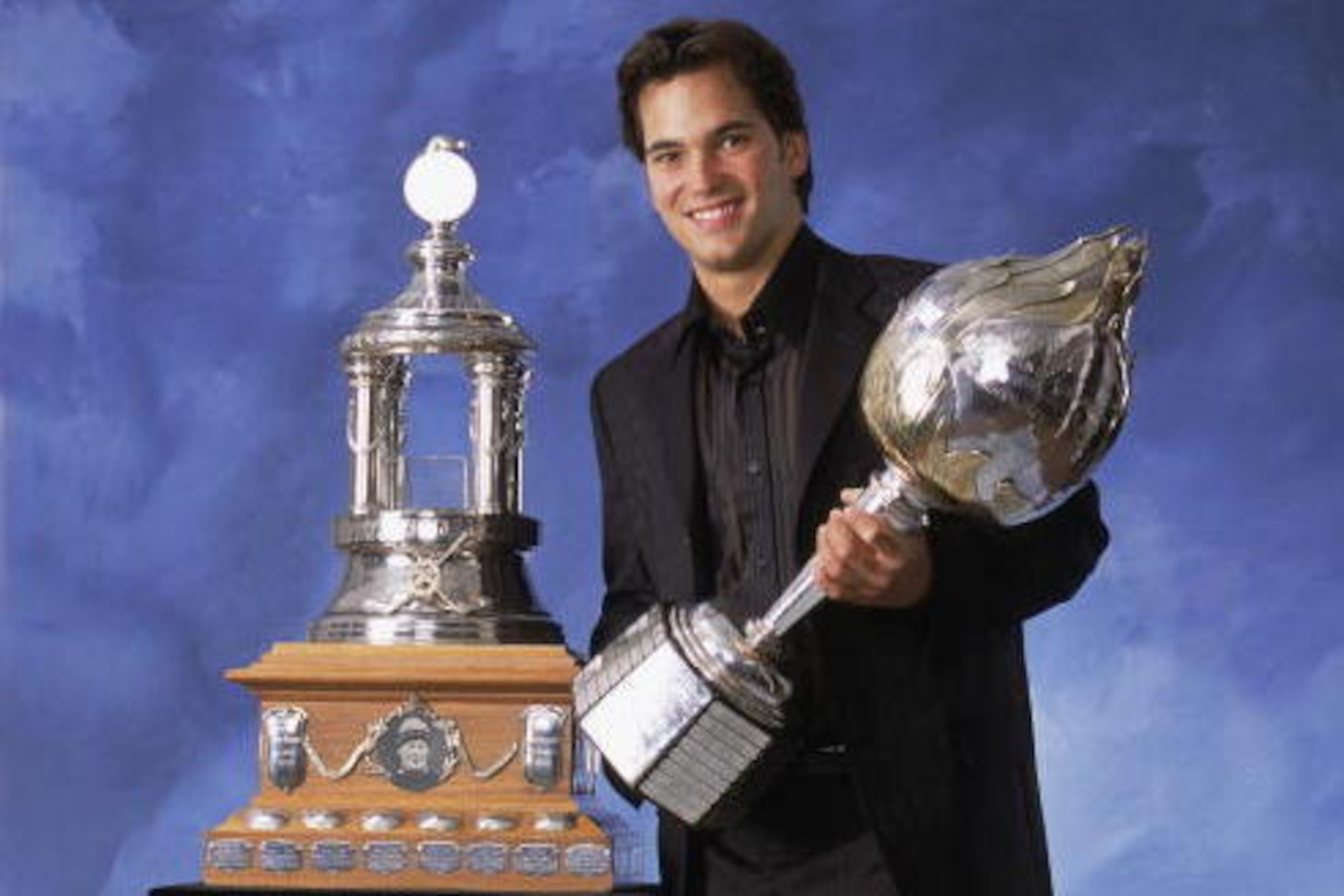 TORONTO, CANADA - JUNE 20:  Jose Theodore of the Montreal Canadiens poses for a studio portrait with the Hart Memorial Trophy, awarded to the 'Most Valuable Player', and the Vezina Trophy, awarded to the 'Outstanding Goaltender', during the NHL Awards in 
