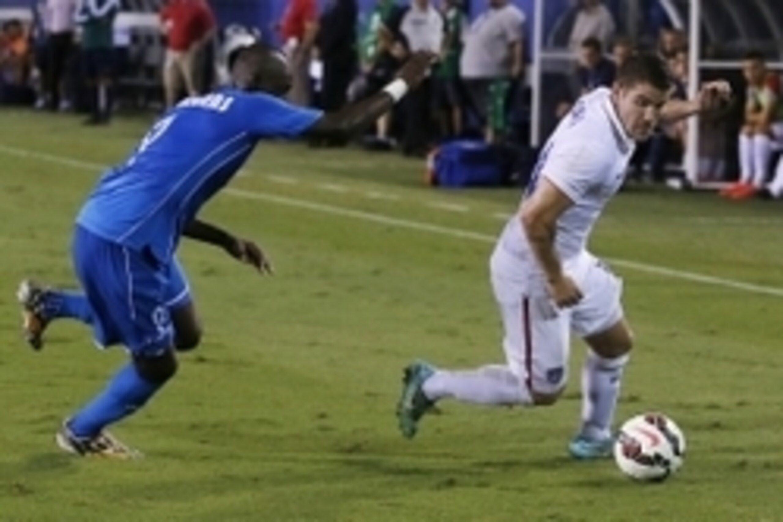 Oct 14, 2014; Boca Raton, FL, USA; USA defender Greg Garza (14) kicks the ball as Honduras  Alberth Elis (9) defends in the second half at FAU Stadium. United States 1 Honduras 1. Mandatory Credit: Robert Mayer-USA TODAY Sports