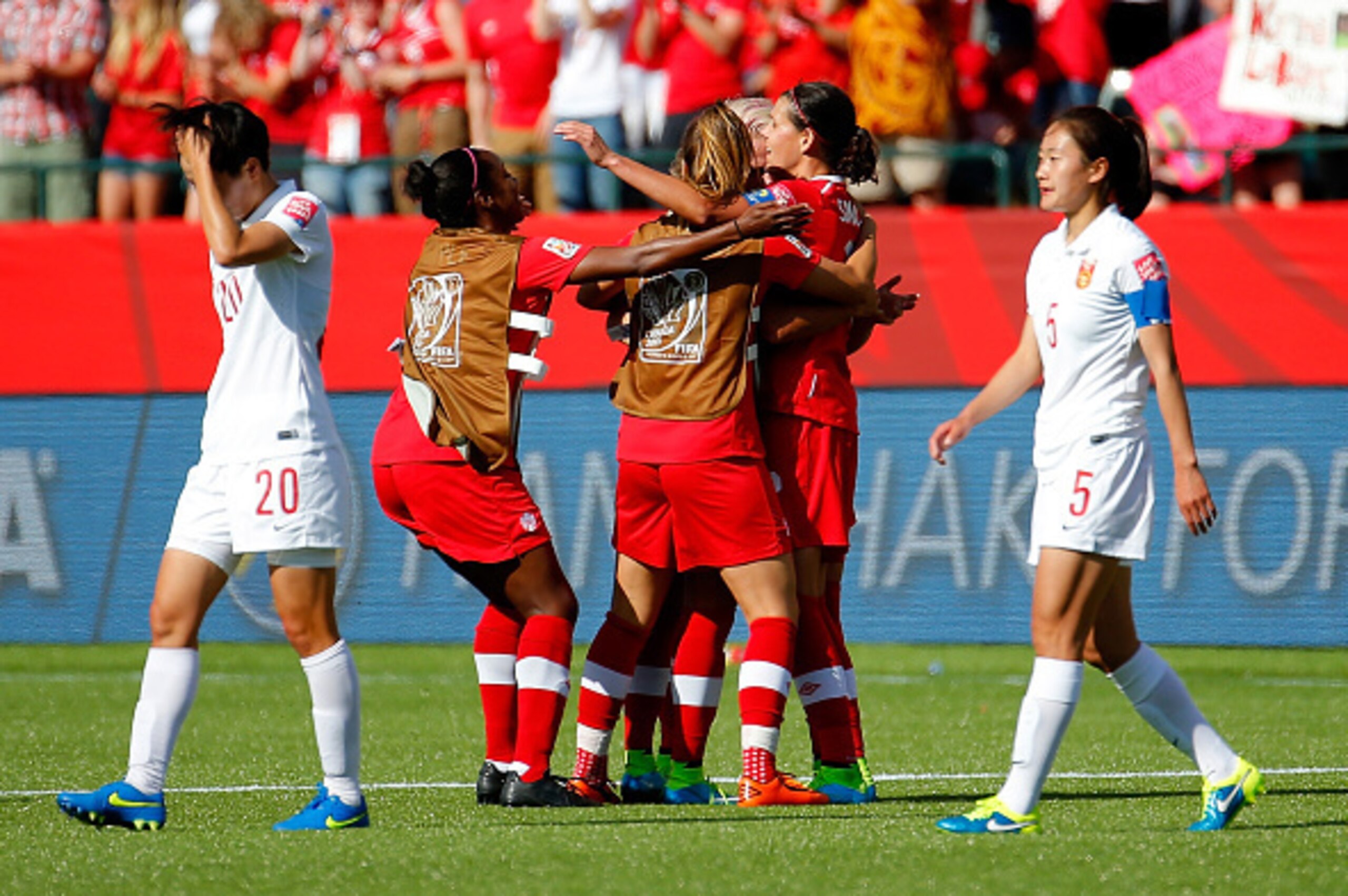 EDMONTON, AB - JUNE 06:  Christine Sinclair #12 of Canada is congratulated by teammates after their 1-0 win over China PR in the FIFA Women's World Cup Canada 2015 Group A match between Canada and China PR at Commonwealth Stadium on June 6, 2015 in Edmont