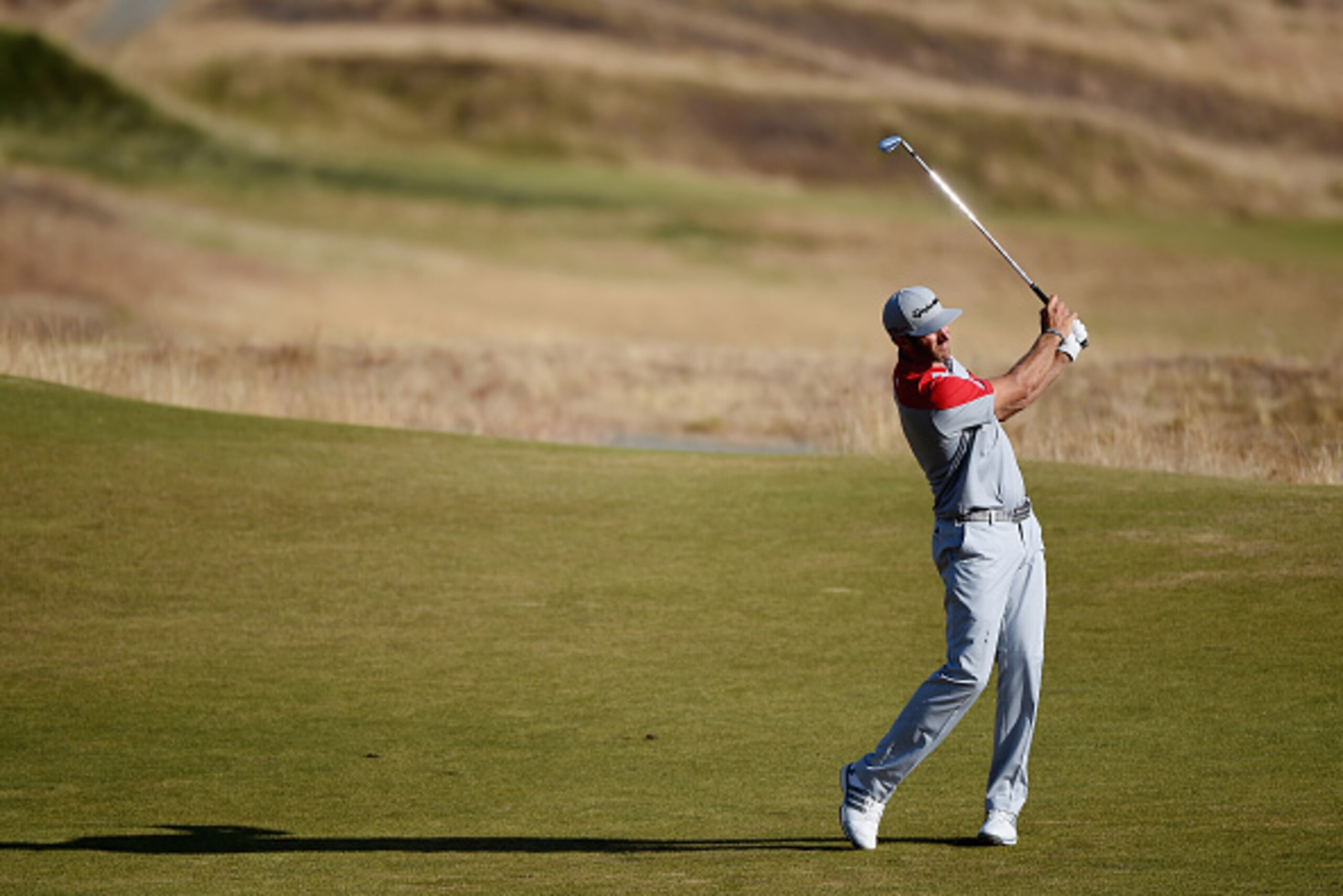 UNIVERSITY PLACE, WA - JUNE 20: Dustin Johnson of the United States hits a shot on the 14th hole during the third round of the 115th U.S. Open Championship at Chambers Bay on June 20, 2015 in University Place, Washington.  (Photo by Harry How/Getty Images