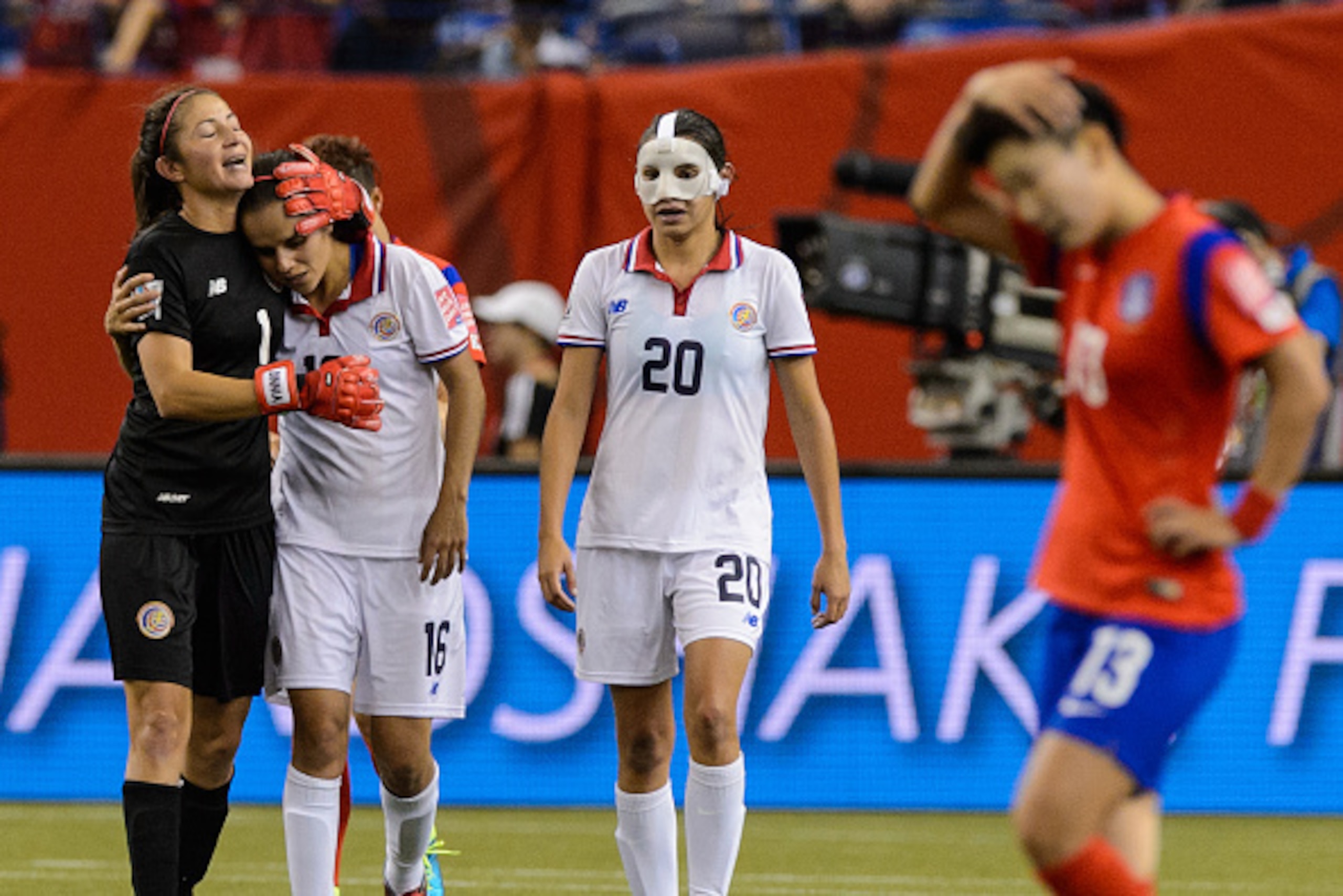 MONTREAL, QC - JUNE 13:  Wendy Acosta #20 of Costa Rica walks beside her emotional teammates Dinnia Diaz #1 and Katherine Alvarado #16 during the 2015 FIFA Women's World Cup Group E match against Korea Republic at Olympic Stadium on June 13, 2015 in Montr