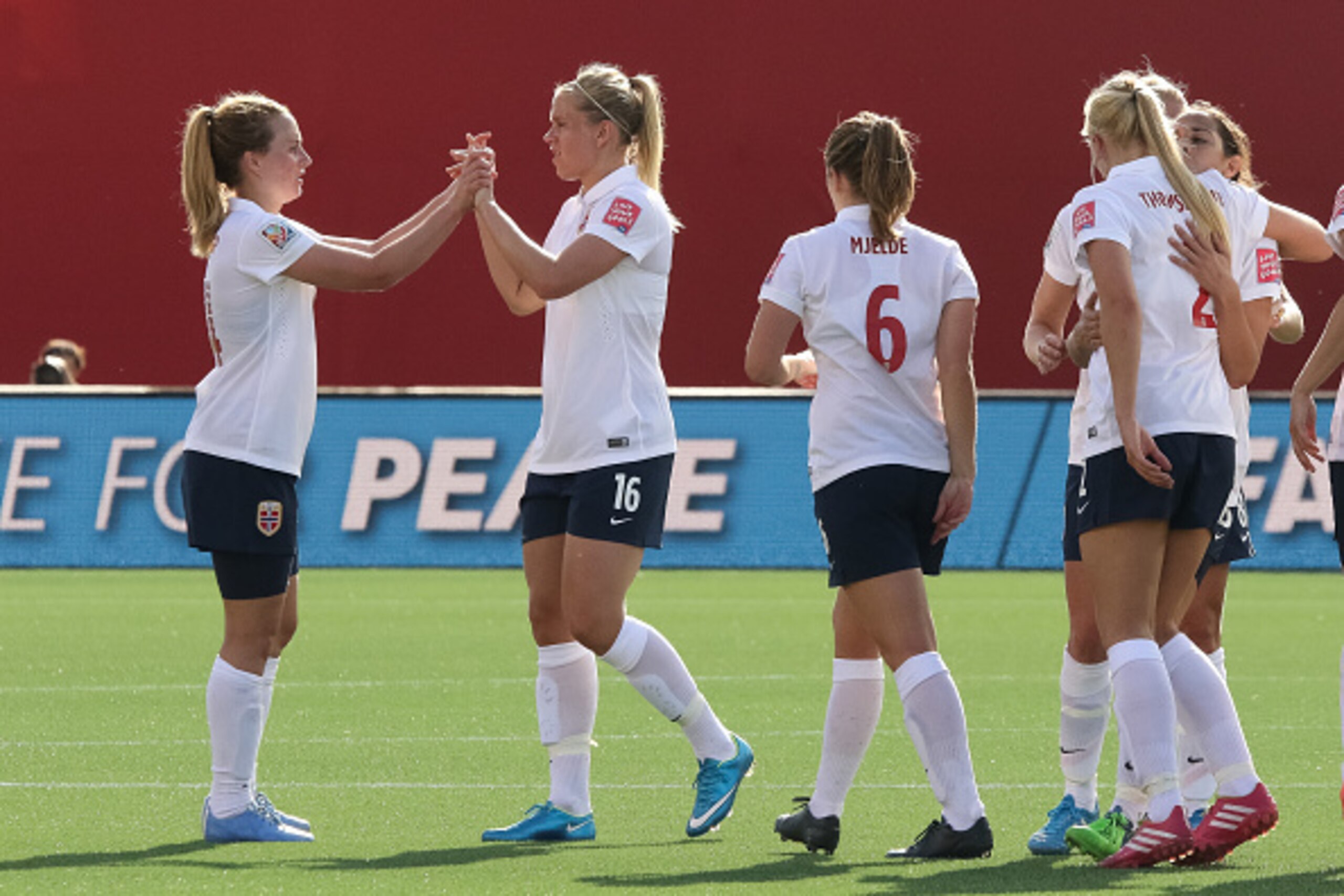 OTTAWA, ON - JUNE 11: Ingrid Schjelderup #14 and Elise Thorsnes #16 celebrate their draw against Germany with teammates after the FIFA Women's World Cup Canada 2015 Group B match between Germany and Norway at Lansdowne Stadium on June 11, 2015 in Ottawa, 