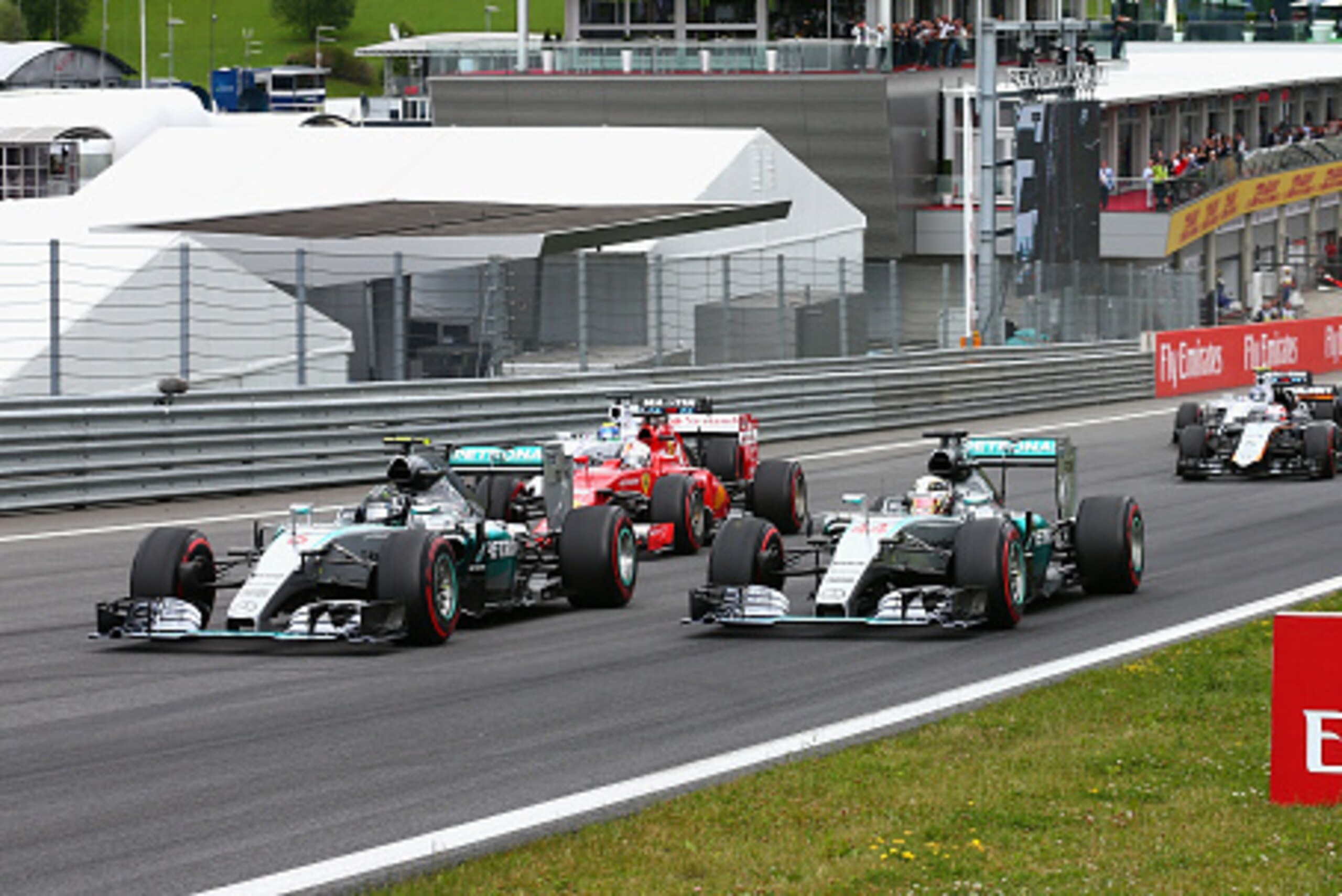 SPIELBERG, AUSTRIA - JUNE 21:  Nico Rosberg of Germany and Mercedes GP leads Lewis Hamilton of Great Britain and Mercedes GP and Sebastian Vettel of Germany and Ferrari as they approach the first corner during the Formula One Grand Prix of Austria at Red 