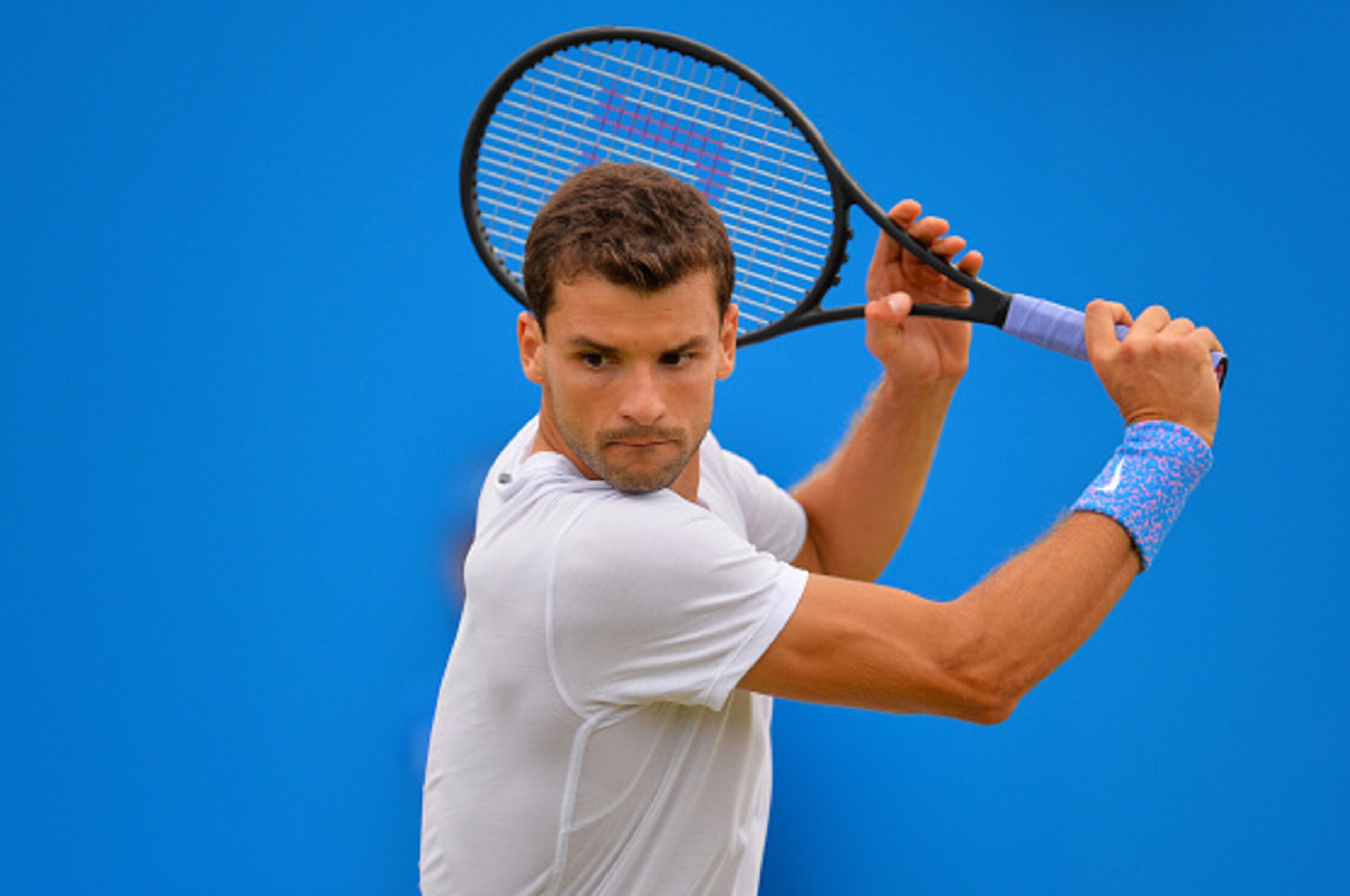 LONDON, ENGLAND - JUNE 17:  Grigor Dimitrov of Bulgaria partnering Stan Wawrinka of Switzerland, in the Men's doubles match against Marcin Matkowski of Poland and Nenad Zimonjic of Serbia during day three of the Aegon Championships at Queen's Club on June