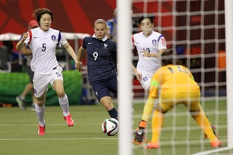 MONTREAL, QC - JUNE 21: Eugenie Le Sommer #9 of France controls the ball past Korea's defence during the FIFA Women's World Cup Canada 2015 round of 16 match between France and Korea Republic at Olympic Stadium on June 21, 2015 in Montreal, Canada.  (Phot