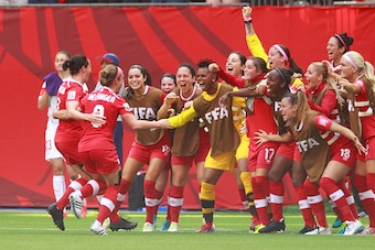 VANCOUVER, BC - JUNE 21: Josee Belanger #9 of Canada is congratulated by teammates after scoring Canada's first goal during the FIFA Women's World Cup Canada 2015 Round 16 match between Switzerland and Canada June 21, 2015 at BC Place Stadium in Vancouver