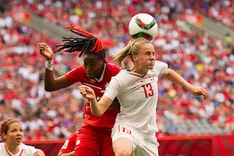 VANCOUVER, BC - JUNE 21: Ana-Maria Crnogorcevic #13 of Switzerland wins a header over Kadeisha Buchanan #3 of Canada during the FIFA Women's World Cup Canada 2015 Round of 16 match between Switzerland and Canada June, 21, 2015 at BC Place Stadium in Vanco
