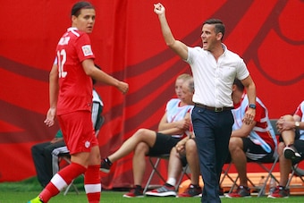 VANCOUVER, BC - JUNE 21: Christine Sinclair #12 of Canada looks on as Canada coach John Herdman yells during the FIFA Women's World Cup Canada 2015 Round 16 match between Switzerland and Canada June 21, 2015 at BC Place Stadium in Vancouver, British Colum