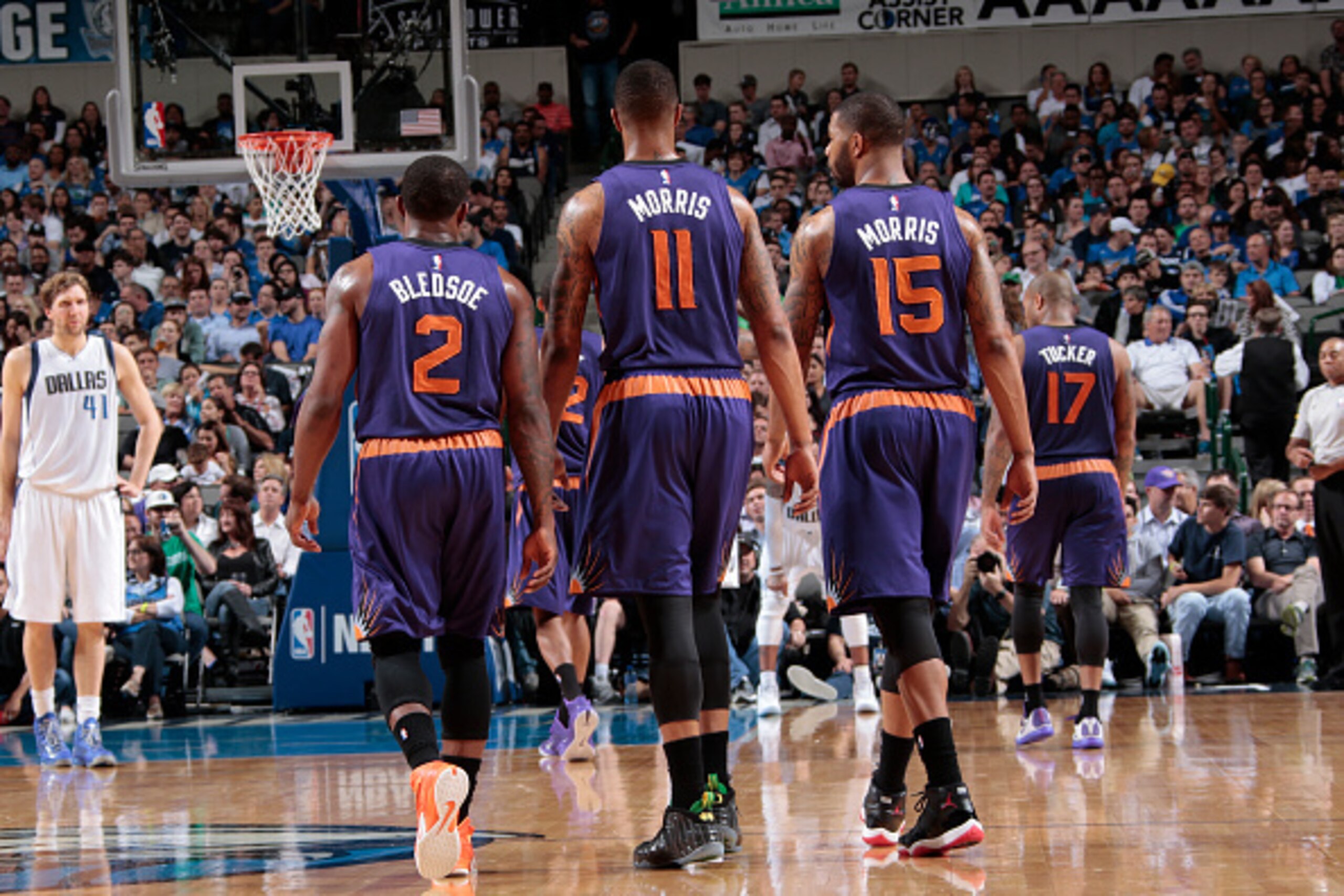 DALLAS, TX - APRIL 8: Eric Bledsoe #2, Markieff Morris #11, and Marcus Morris #15 of the Phoenix Suns stand on the court during a game against the Dallas Mavericks on April 8, 2015 at the American Airlines Center in Dallas, Texas. NOTE TO USER: User expre