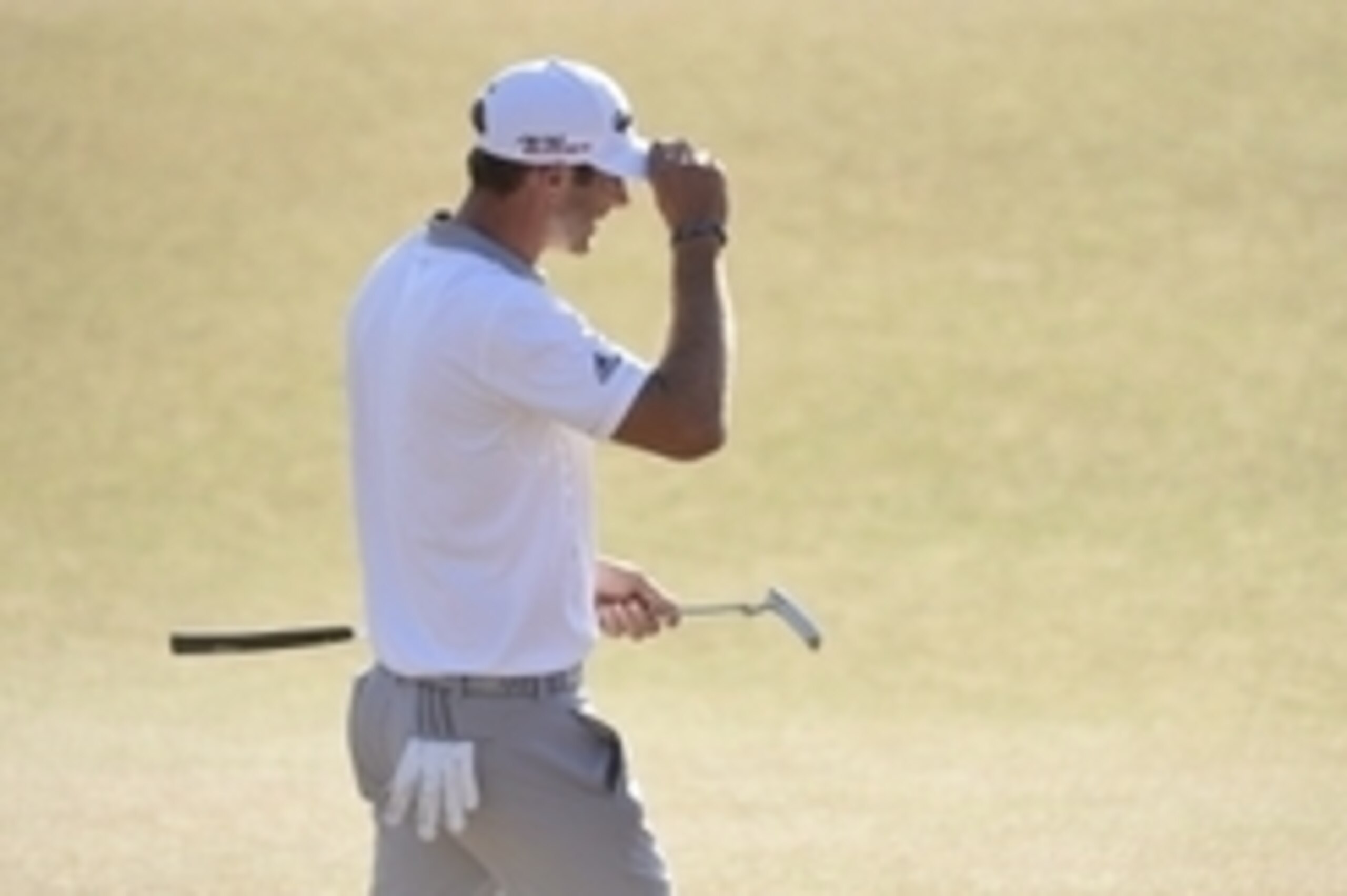 Jun 21, 2015; University Place, WA, USA; Dustin Johnson reacts after missing his birdie putt on the 18th green in the final round of the 2015 U.S. Open golf tournament at Chambers Bay. Mandatory Credit: Kyle Terada-USA TODAY Sports