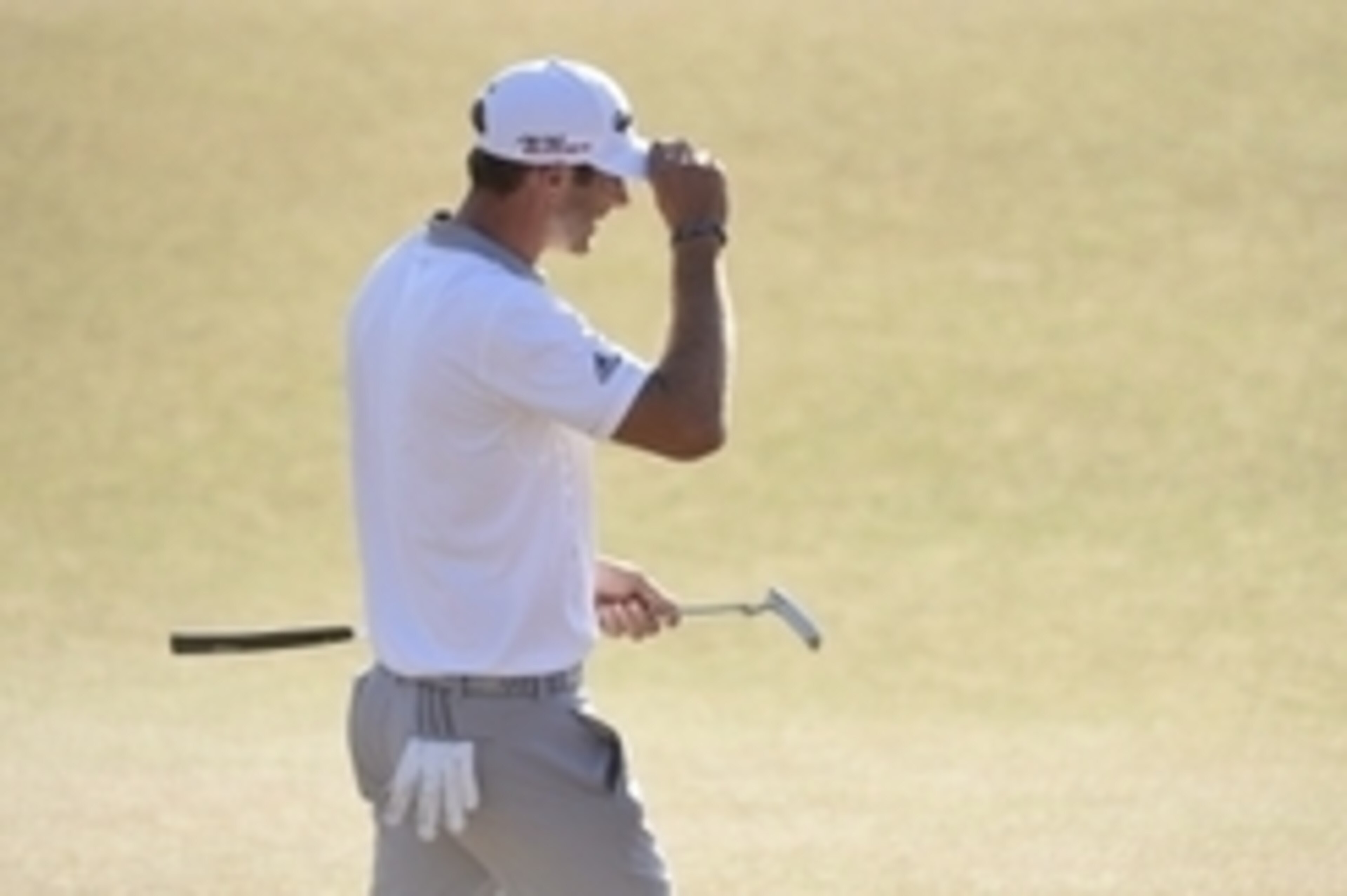 Jun 21, 2015; University Place, WA, USA; Dustin Johnson reacts after missing his birdie putt on the 18th green in the final round of the 2015 U.S. Open golf tournament at Chambers Bay. Mandatory Credit: Kyle Terada-USA TODAY Sports