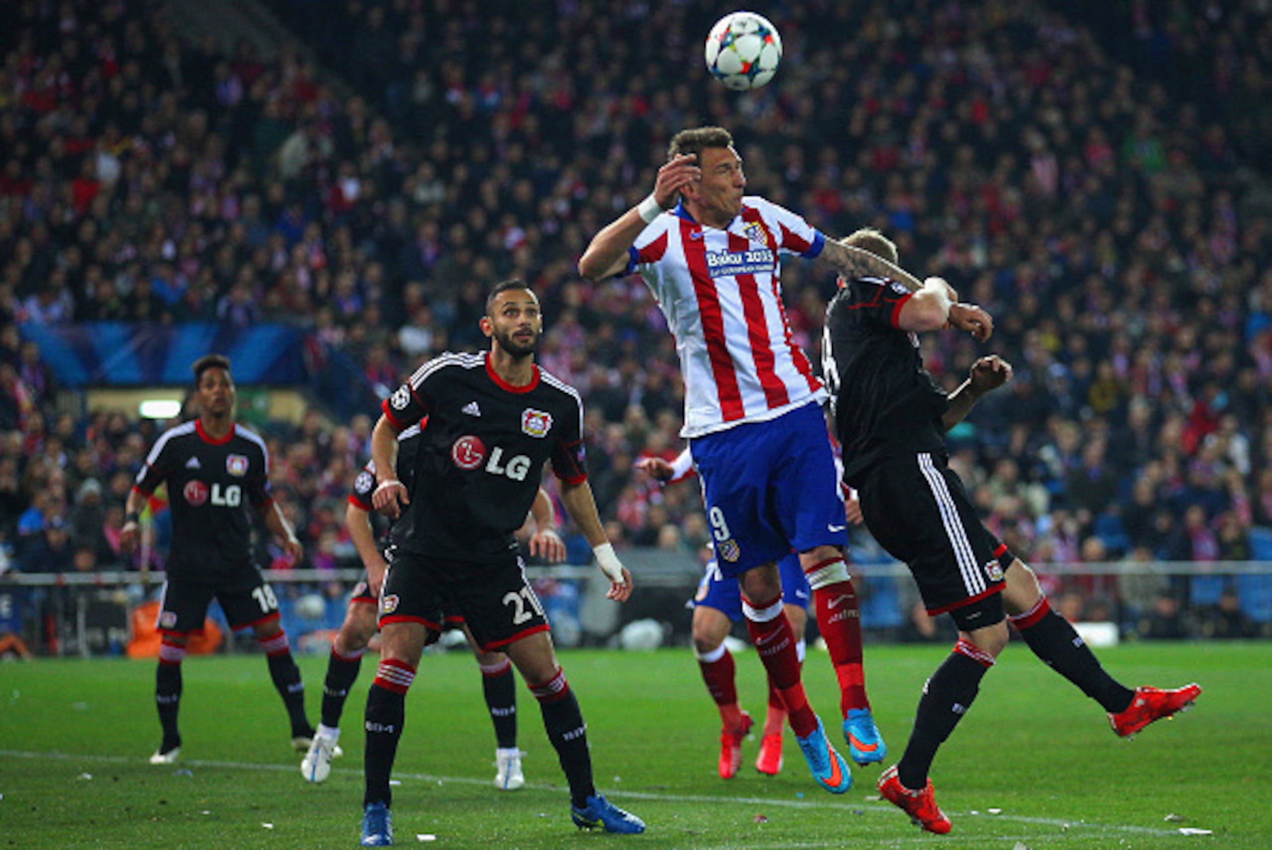 MADRID, SPAIN - MARCH 17: Mario Mandzukic of Atletico Madrid climibs for the header during the UEFA Champions League round of 16 match between Club Atletico de Madrid and Bayer 04 Leverkusen at Vicente Calderon Stadium on March 17, 2015 in Madrid, Spain. 