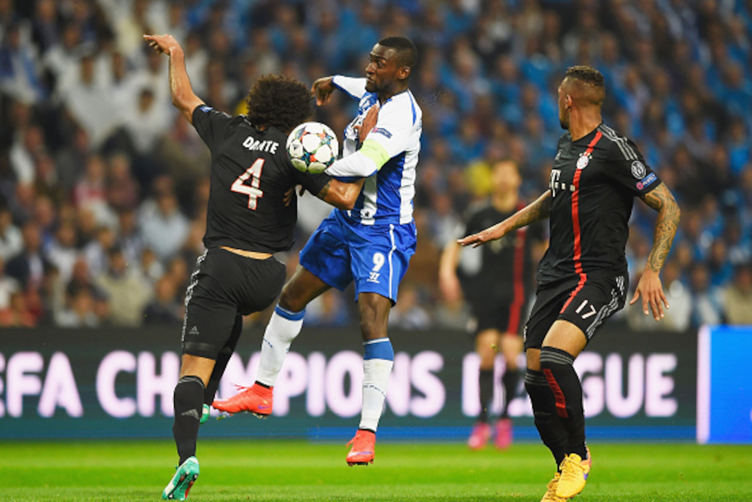 PORTO, PORTUGAL - APRIL 15:  Jackson Martinez of FC Porto battles with Dante of Bayern Muenchen (4) as Jerome Boateng of Bayern Muenchen (17) looks on during the UEFA Champions League Quarter Final first leg match between FC Porto and FC Bayern Muenchen a