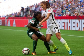 VANCOUVER, BC - JUNE 16: Alex Morgan #13 of the United States tires to get past Sarah Nnodim #22 of Nigeria during the FIFA Women's World Cup Canada 2015 Group D match between Nigeria and The United States June, 16, 2015 at BC Place Stadium in Vancouver, 