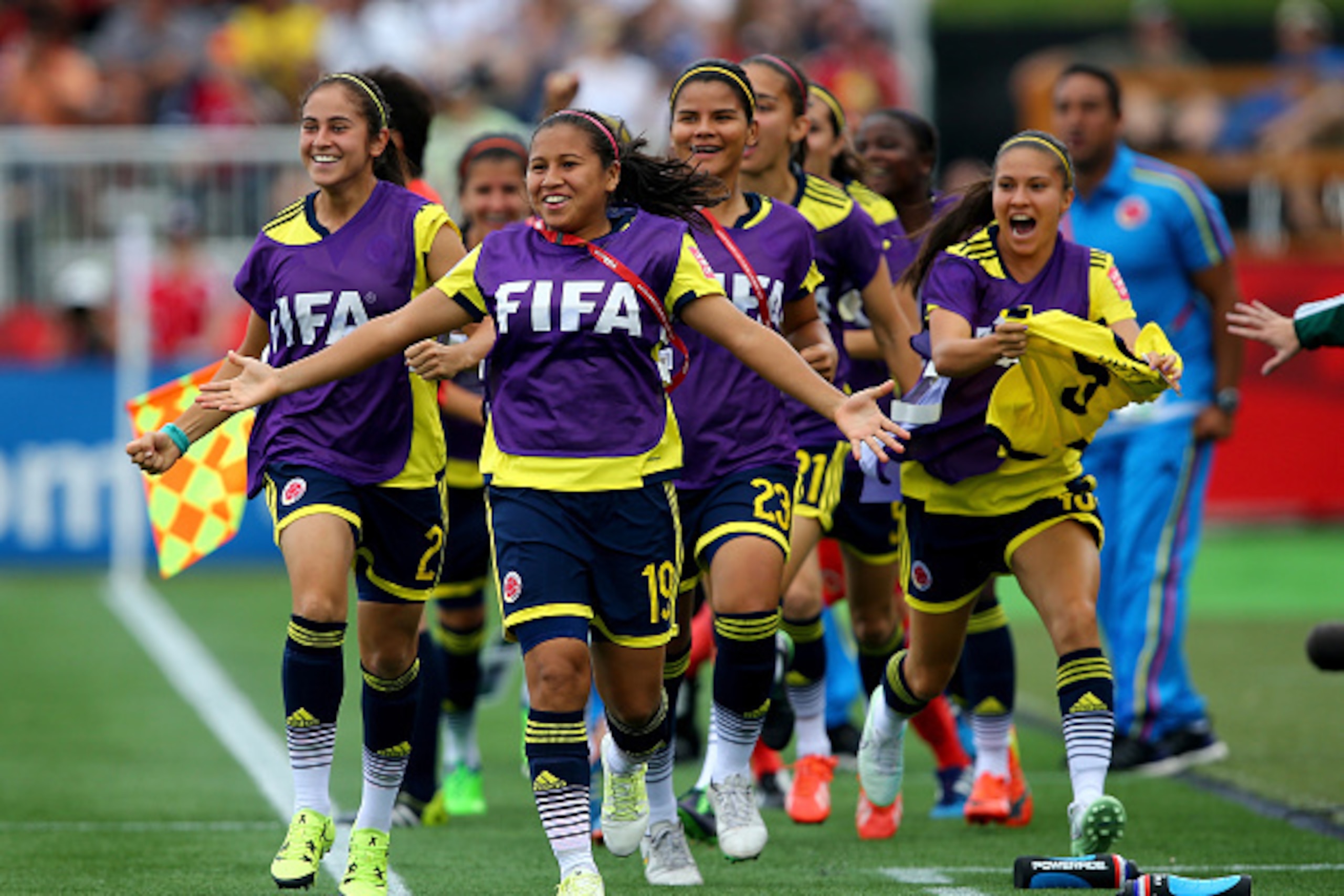 MONCTON, NB - JUNE 13:  Leicy Santos #19 of Colombia leads the players on the bench as they greet Lady Andrade after she scored in the first half against the France during the FIFA Women's World Cup 2015 Group F match at Moncton Stadium on June 13, 2015 i