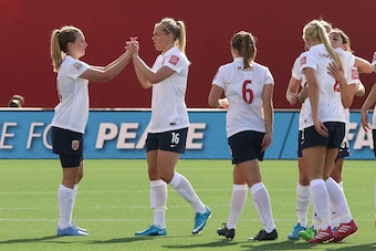 OTTAWA, ON - JUNE 11: Ingrid Schjelderup #14 and Elise Thorsnes #16 celebrate their draw against Germany with teammates after the FIFA Women's World Cup Canada 2015 Group B match between Germany and Norway at Lansdowne Stadium on June 11, 2015 in Ottawa, 