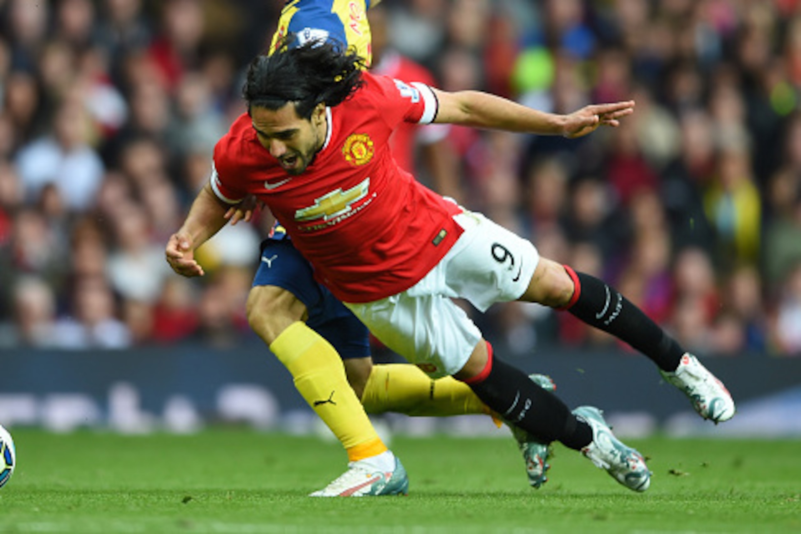 MANCHESTER, ENGLAND - MAY 17:  Radamel Falcao Garcia of Manchester United is challenged by Nacho Monreal of Arsenal during the Barclays Premier League match between Manchester United and Arsenal at Old Trafford on May 17, 2015 in Manchester, England.  (Ph