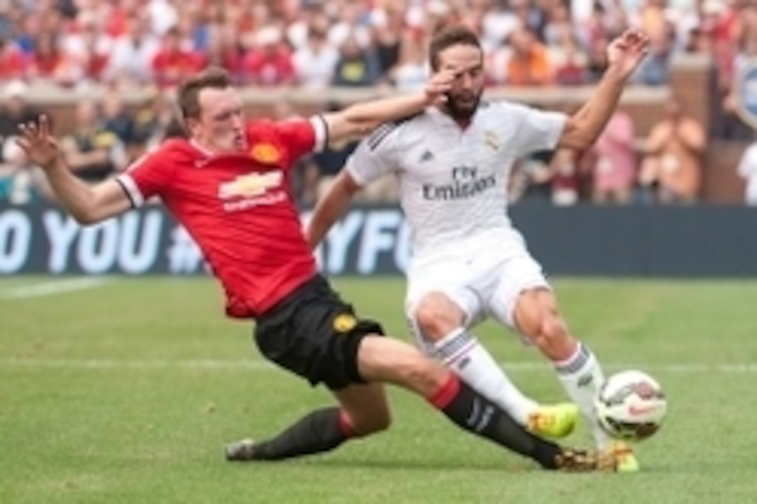 Aug 2, 2014; Ann Arbor, MI, USA; Manchester United defender Phil Jones (4) collides with Real Madrid defender Daniel Carvajal (15) during the first half at Michigan Stadium. Mandatory Credit: Tim Fuller-USA TODAY Sports
